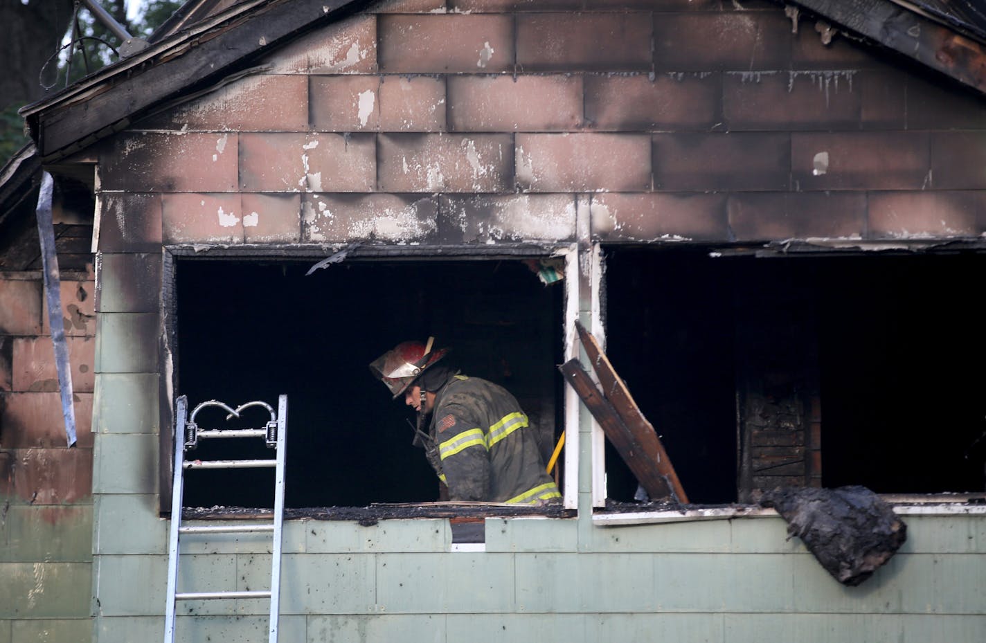 A Minneapolis firefighter looks over the scene of a duplex fire that gutted the upstairs and left two seriously burned Thursday, Sept. 28, 2017, in Minneapolis. DAVID JOLES &#xef; david.joles@startribune.com Aftermath of duplex fire in which two people were injured.