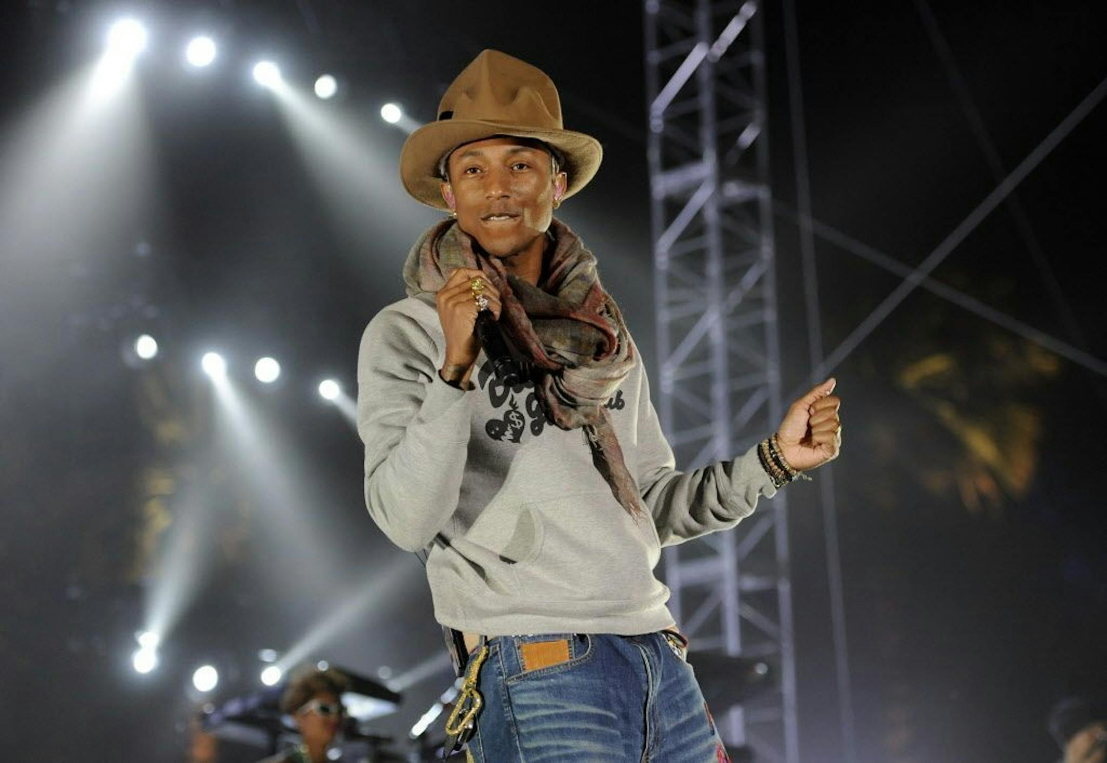 FILE - In this April 12, 2014 file photo, Pharrell Williams performs at the 2014 Coachella Music and Arts Festival in Indio, Calif. Expect chic men's shorts and maybe even a tall hat: Pharrell is being honored by the fashion industry. The producer-singer-songwriter is this year's Fashion Icon at the annual Council of Fashion Designers of America awards, a glittery evening that brings a host of top fashion designers to New York's Lincoln Center along with celebrities like Kim Kardashian, who was