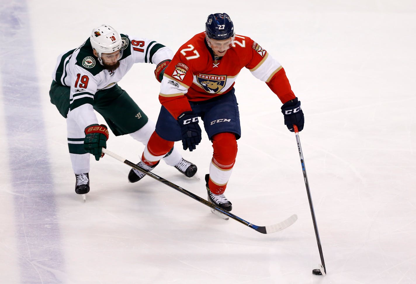 Minnesota Wild center Martin Hanzal (19) and Florida Panthers center Nick Bjugstad (27) battle for the puck during the first period of an NHL hockey game, Friday, March 10, 2017, in Sunrise, Fla.