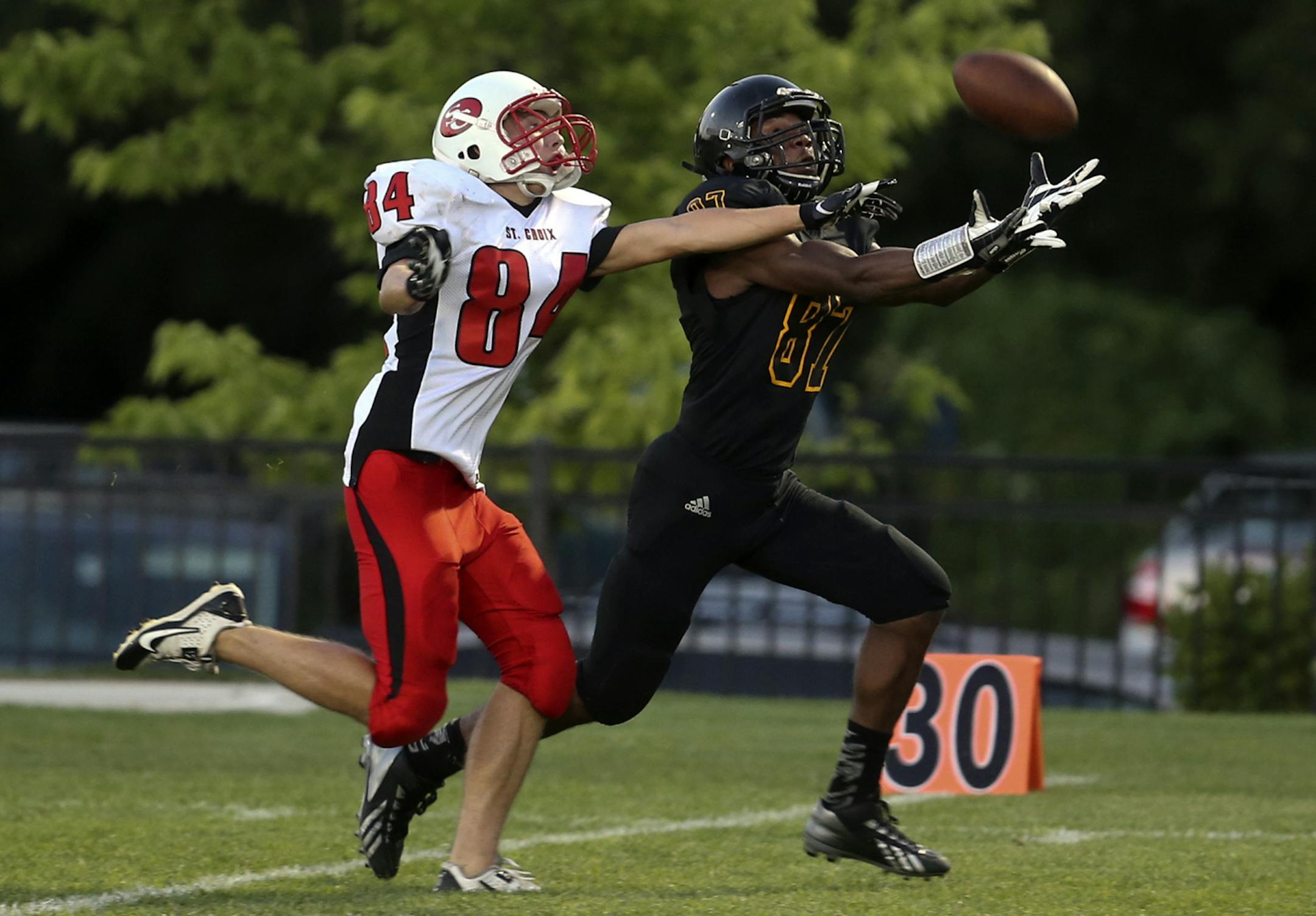 DeLaSalle receiver Darryl Atkins Jr. hauls in a long pass from quarteback Billy Hart as St. Croix Lutheran's Aaron Zoellner (84) defended during second quarter actionFriday, Aug. 30, 2013, at DeLaSalle High in Minneapolis, MN.](DAVID JOLES/STARTRIBUNE) djoles@startribune.com High School football at St. Croix Lutheran at DeLaSalle High Friday, Aug. 30, 2013, in Minneapolis, MN.**Darryl Atkins Jr., Aaron Zoellner ,cq