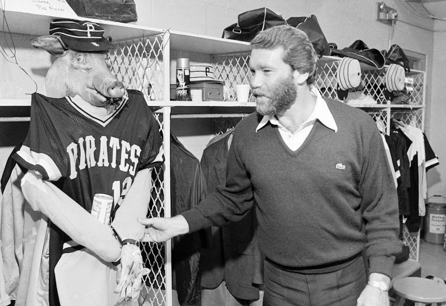 Pirates' pitcher Jim Booker examines an effigy of himself hung on his locker in Baltimore on Oct. 9, 1979 by Bert Blyleven before tonight's first game of World Series against the Orioles. Blyleven bought the pig head at a nearby meat market.