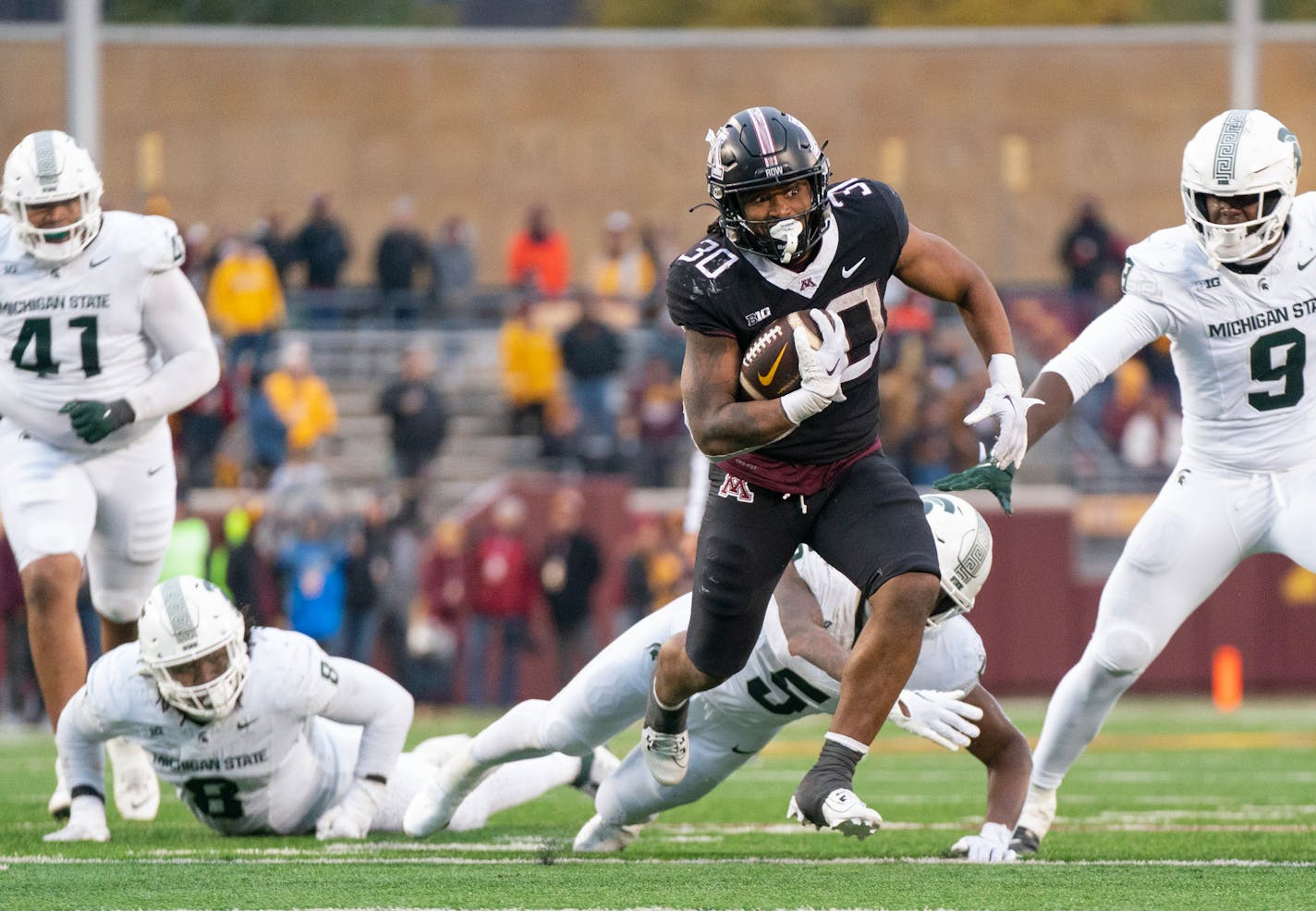 Minnesota running back Jordan Nubin (30) evades a tackle attempt by Michigan State linebacker Jordan Hall (5) in the fourth quarter Saturday, Oct. 28, 2023, at Huntington Bank Stadium in Minneapolis, Minn. ]