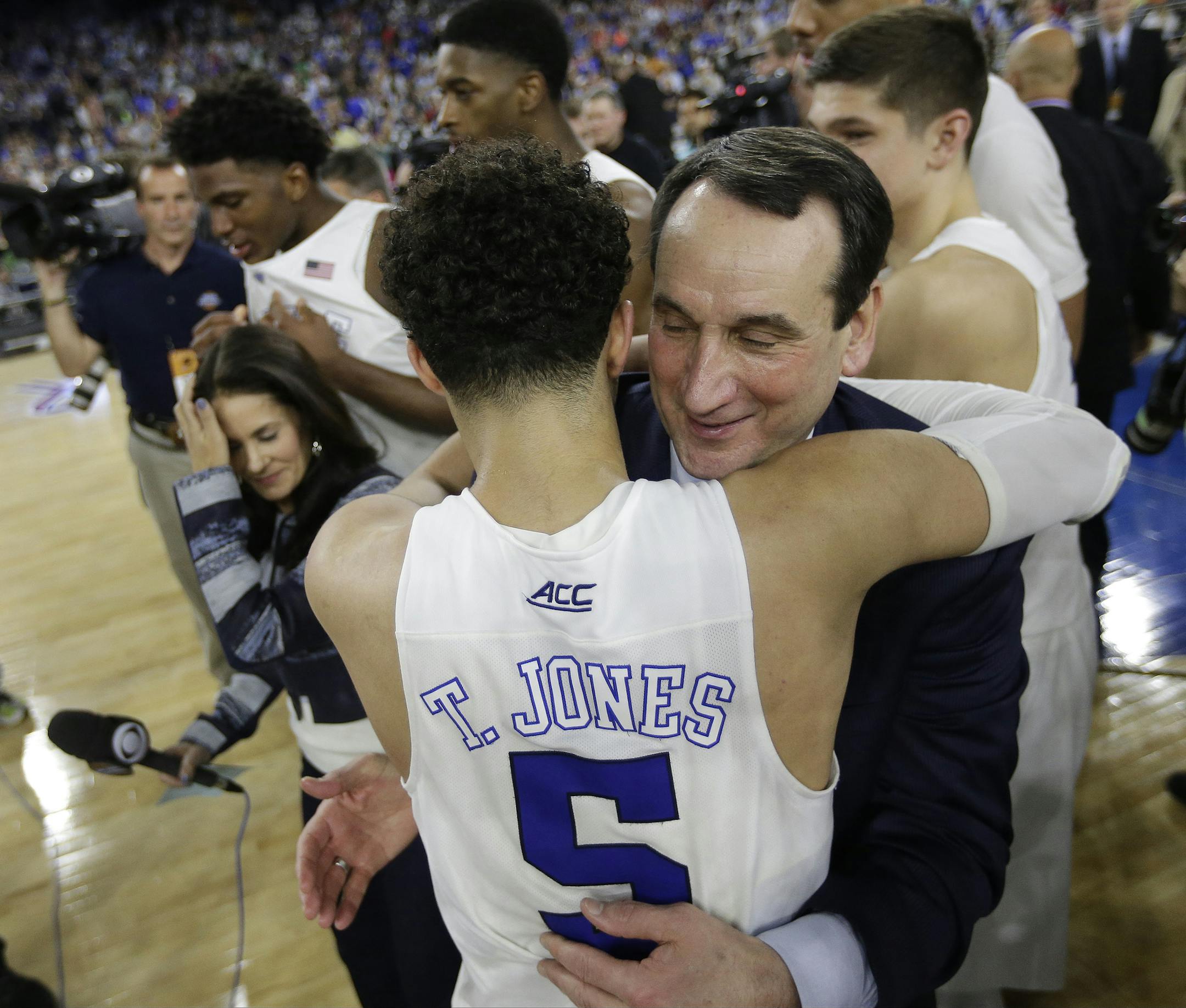 Duke head coach Mike Krzyzewski hugs Tyus Jones (5) after a college basketball regional final game against Gonzaga in the NCAA Tournament Sunday, March 29, 2015, in Houston. Duke won 66-52 to advance to the Final Four. (AP Photo/Charlie Riedel)