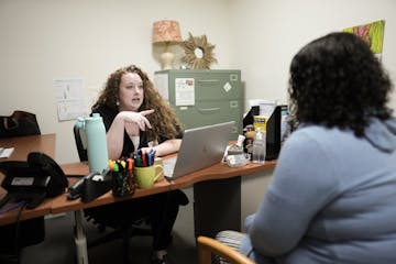 Andrea Hervey and Bridget Glass discussed housing challenges clients face last week at PRISM in Golden Valley. 