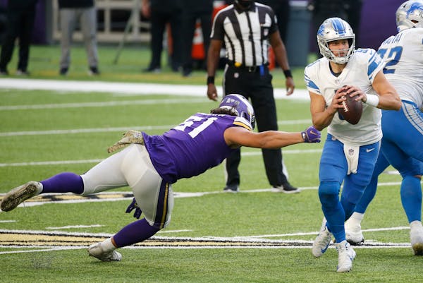 Lions quarterback Matthew Stafford runs from Vikings defensive tackle Hercules Mata'afa on Nov. 8.
