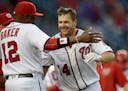 The Nationals' Chris Heisey (14) celebrated with manager Dusty Baker after Heisey hit a walk-off home run during the 16th inning against the Twins on 