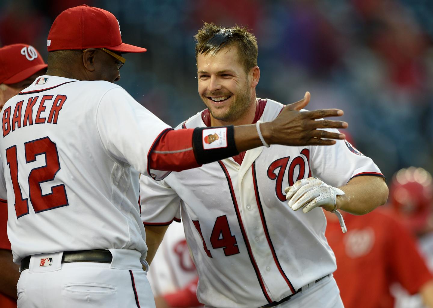 The Nationals' Chris Heisey (14) celebrated with manager Dusty Baker after Heisey hit a walk-off home run during the 16th inning against the Twins on Sunday. The Nationals won 6-5 in 16 innings.