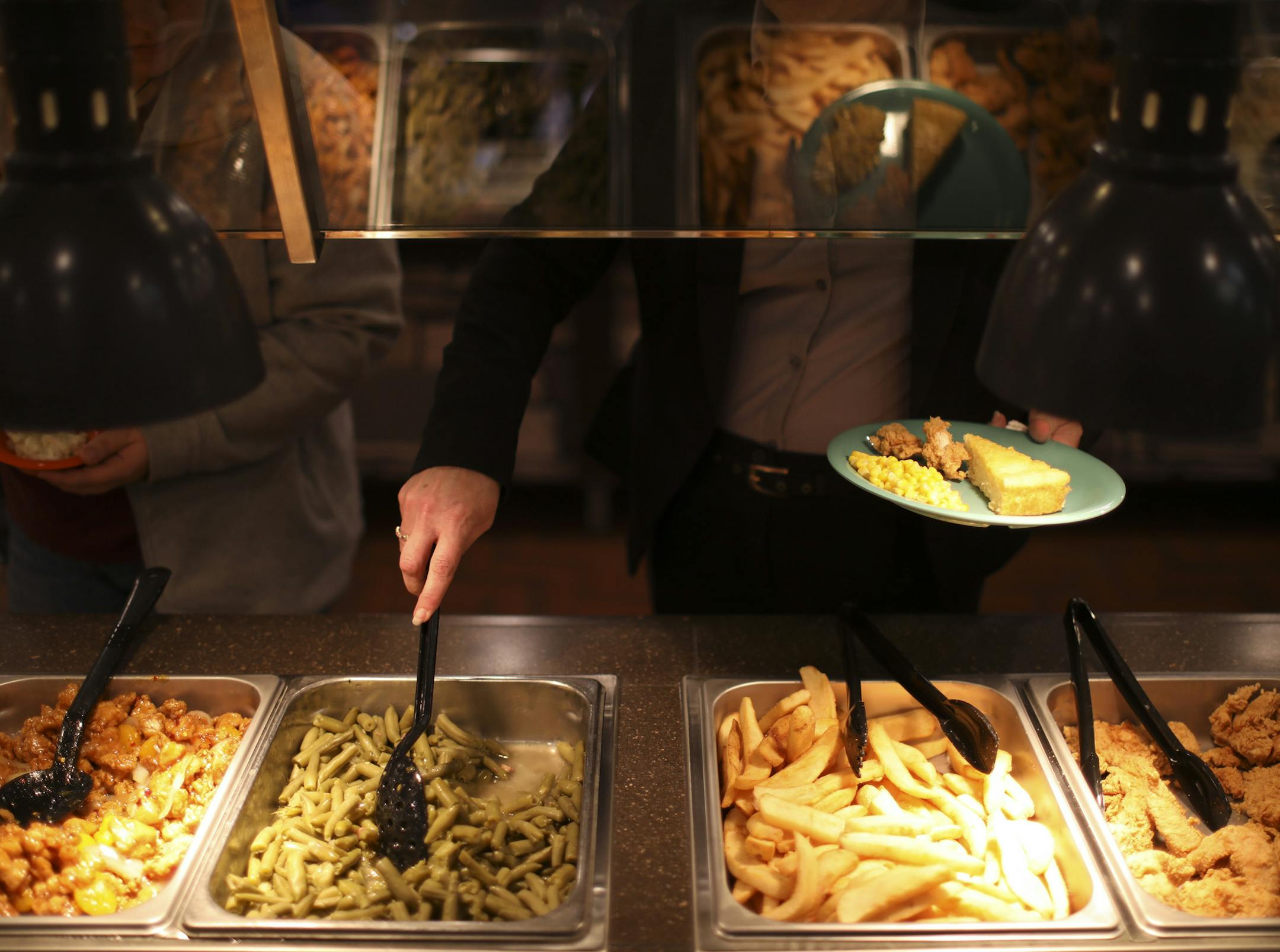 Employees feasted on food prepared as a test run for the kitchen before tomorrow's grand opening of the Golden Corral in Maplewood. ] JEFF WHEELER &#xef; jeff.wheeler@startribune.com Employees were making final preparations for tomorrow's grand opening of the Golden Corral in a Maplewood location formerly occupied by an Old Country Buffet. The second Twin Cities location for the chain was photographed Wednesday afternoon, December 7, 2016.