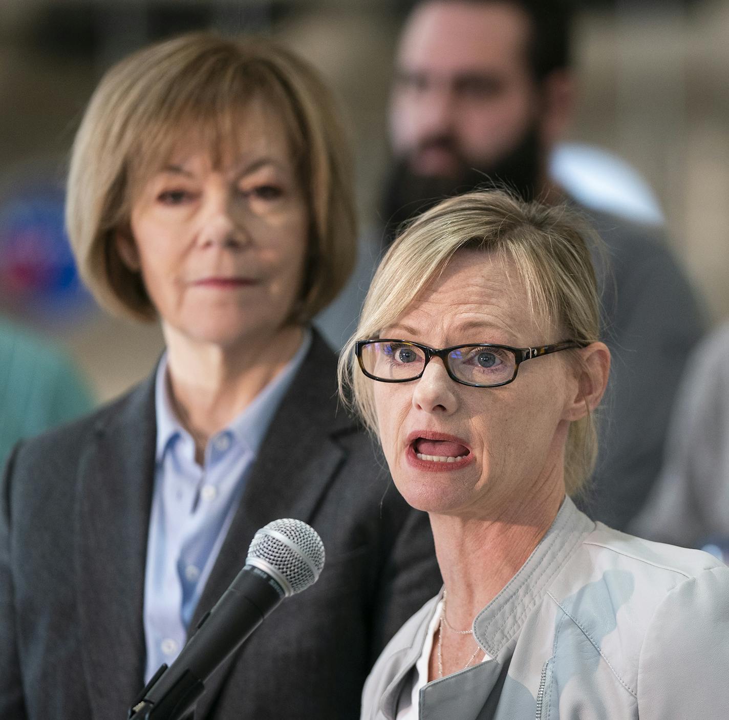 Celia Hahn, a TSA employee who is currently working without pay, speaks during the news conference as U.S. Sen. Tina Smith (D-Minn.) stands beside her. ] LEILA NAVIDI &#xa5; leila.navidi@startribune.com BACKGROUND INFORMATION: U.S. Sen. Tina Smith (D-Minn.) holds a news conference with Minnesotans hurt by the ongoing federal government shutdown to discuss the shutdown's implications for the state at Minneapolis-St. Paul International Airport in Bloomington on Friday, January 11, 2019. Friday mar