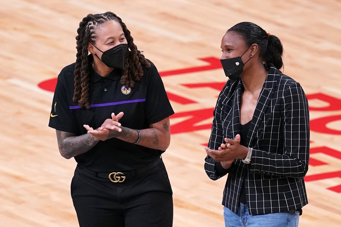 L.A. assistant coach and former Lynx star Seimone Augustus greeted fellow former Lynx star Rebekkah Brunson. Both will have their jerseys retired by the team next season.