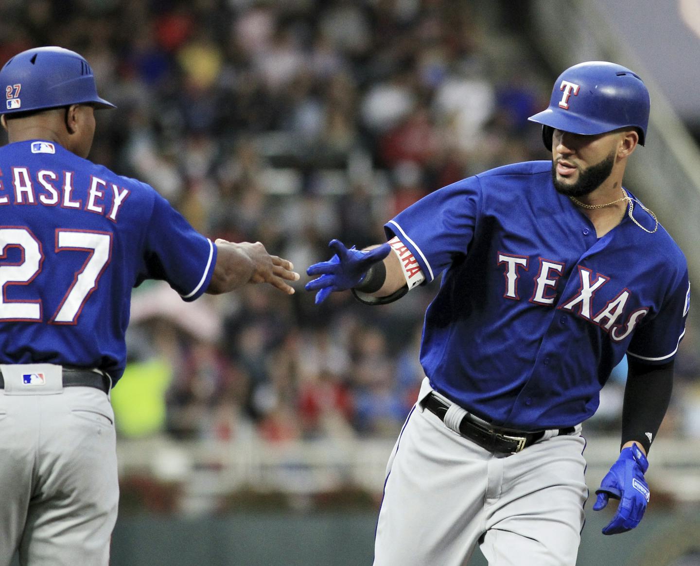 Texas Rangers' Nomar Mazara, right, is congratulated by third base coach Tony Beasley (27) after hitting a two-run home run against the Minnesota Twins in the first inning during a baseball game on Saturday, Aug. 5, 2017, in Minneapolis. (AP Photo/Andy Clayton-King)