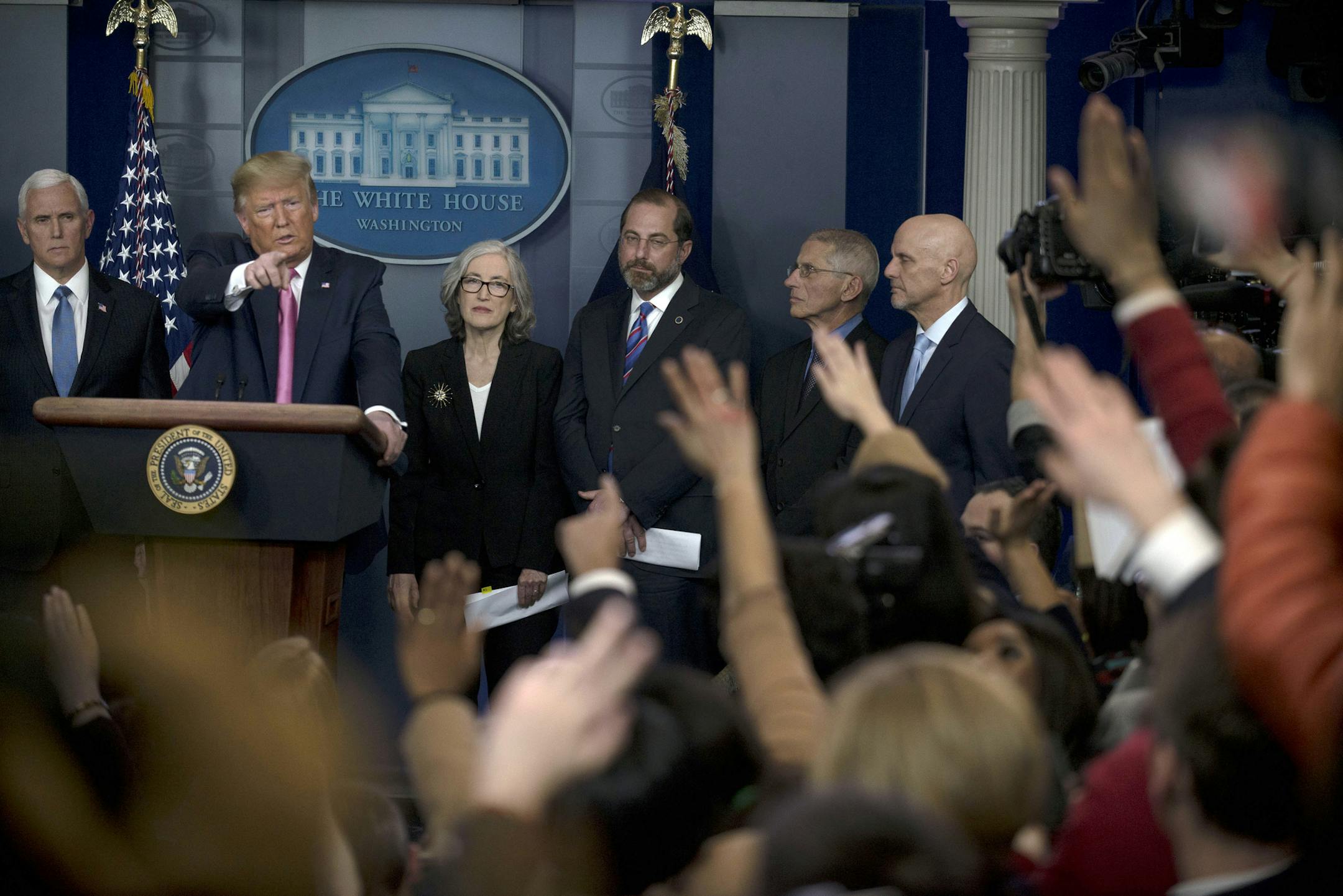 President Donald Trump takes a question during a news conference on the coronavirus outbreak at the White House briefing room on Wednesday, Feb. 26, 2020. Trump named Vice President Mike Pence, left, to coordinate the government’s response to the coronavirus, even as he repeatedly played down the danger to the U.S. of a widespread domestic outbreak. (Gabriella Demczuk/The New York Times)