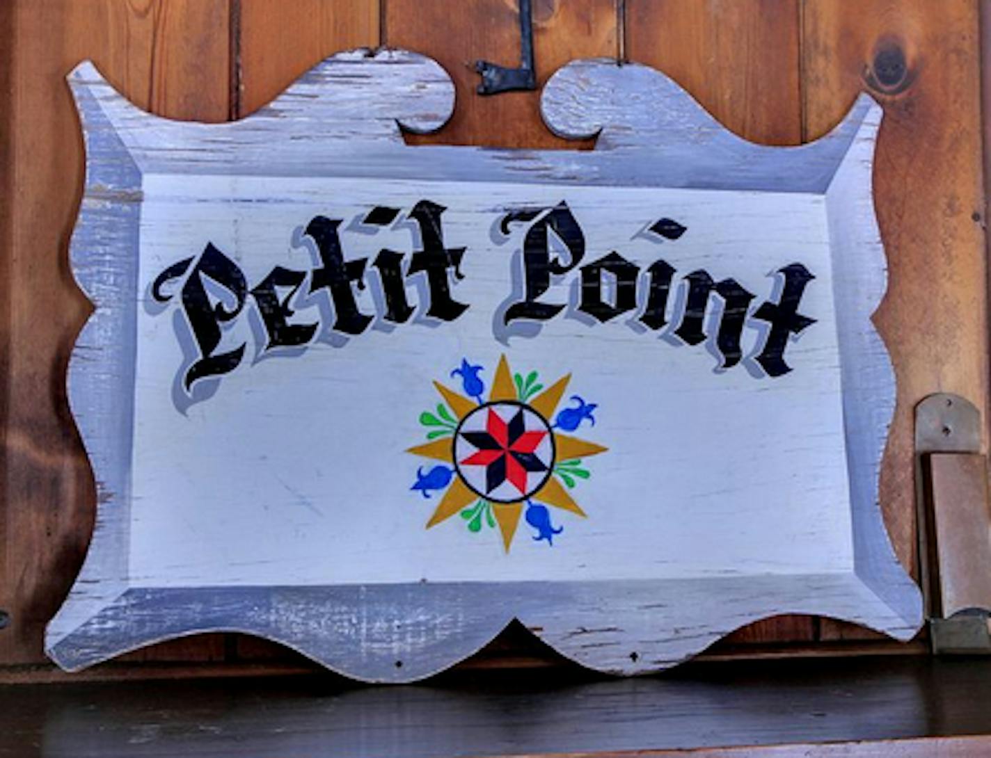 A vintage sign with the home's name, Petit Point.