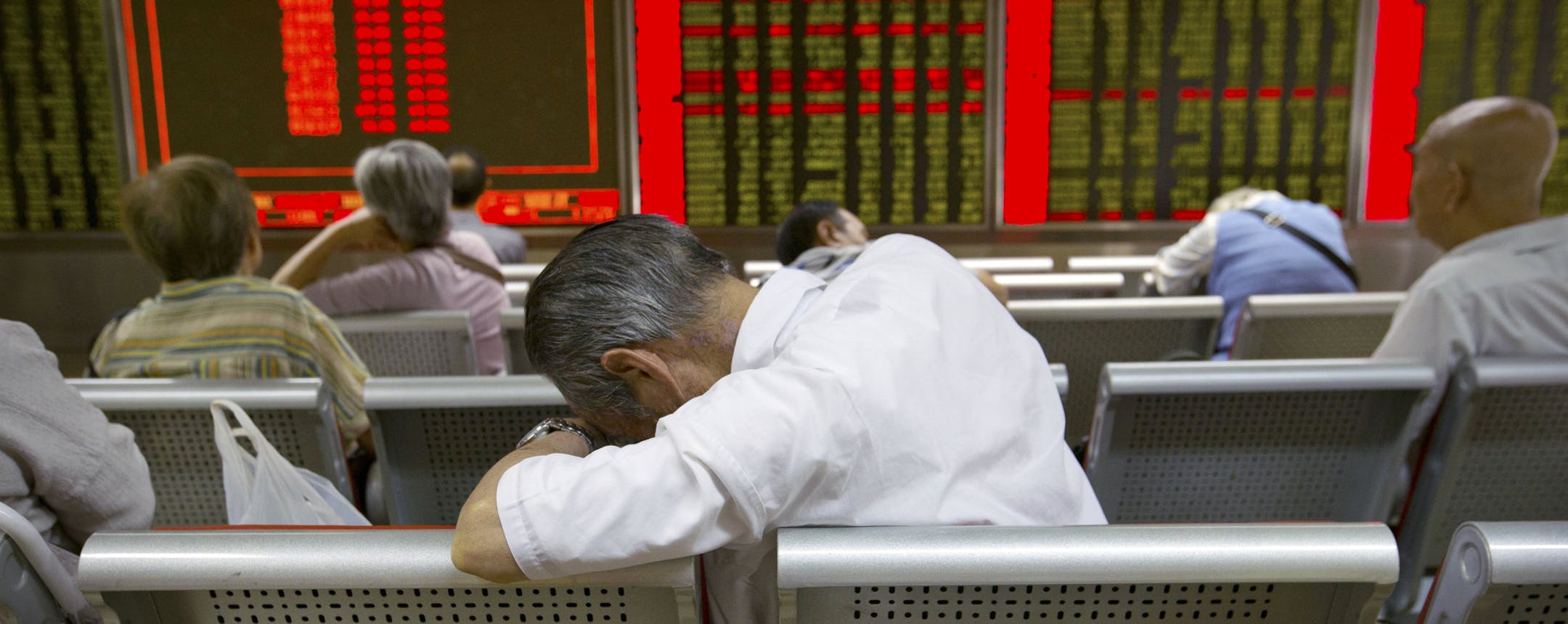 FILE - In this Tuesday, Aug. 25, 2015, file photo, Chinese investors monitor stock prices at a brokerage house in Beijing. Volatility in Chinese stocks roiled global markets this week, showing how big and closely-watched China's market has become - and reminding investors that stock markets&#x2020;can and do swing wildly. (AP Photo/Mark Schiefelbein, File)