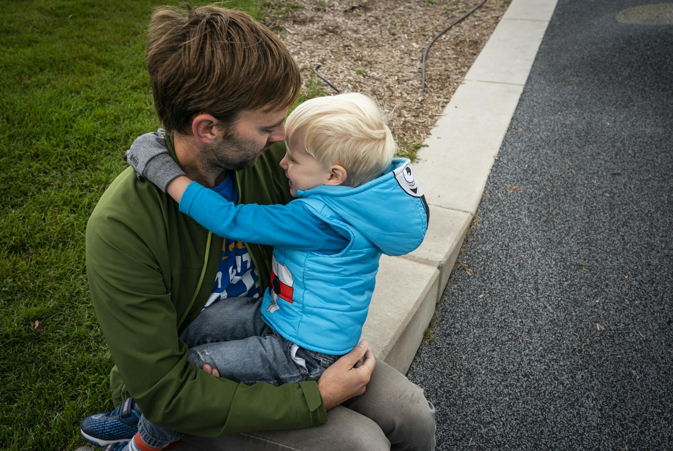 Keith Nagel hugs his son Sawyer, 3, during a Twin Cities Dads playgroup at Central Park in Maple Grove.