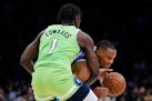 Los Angeles Lakers' Russell Westbrook is defended by Minnesota Timberwolves' Anthony Edwards during the first half of an NBA basketball game Friday, N