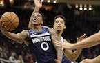Minnesota Timberwolves guard Jeff Teague gets around the defense of Milwaukee Bucks guard Malcolm Brogdon as he drives to the basket during the first 