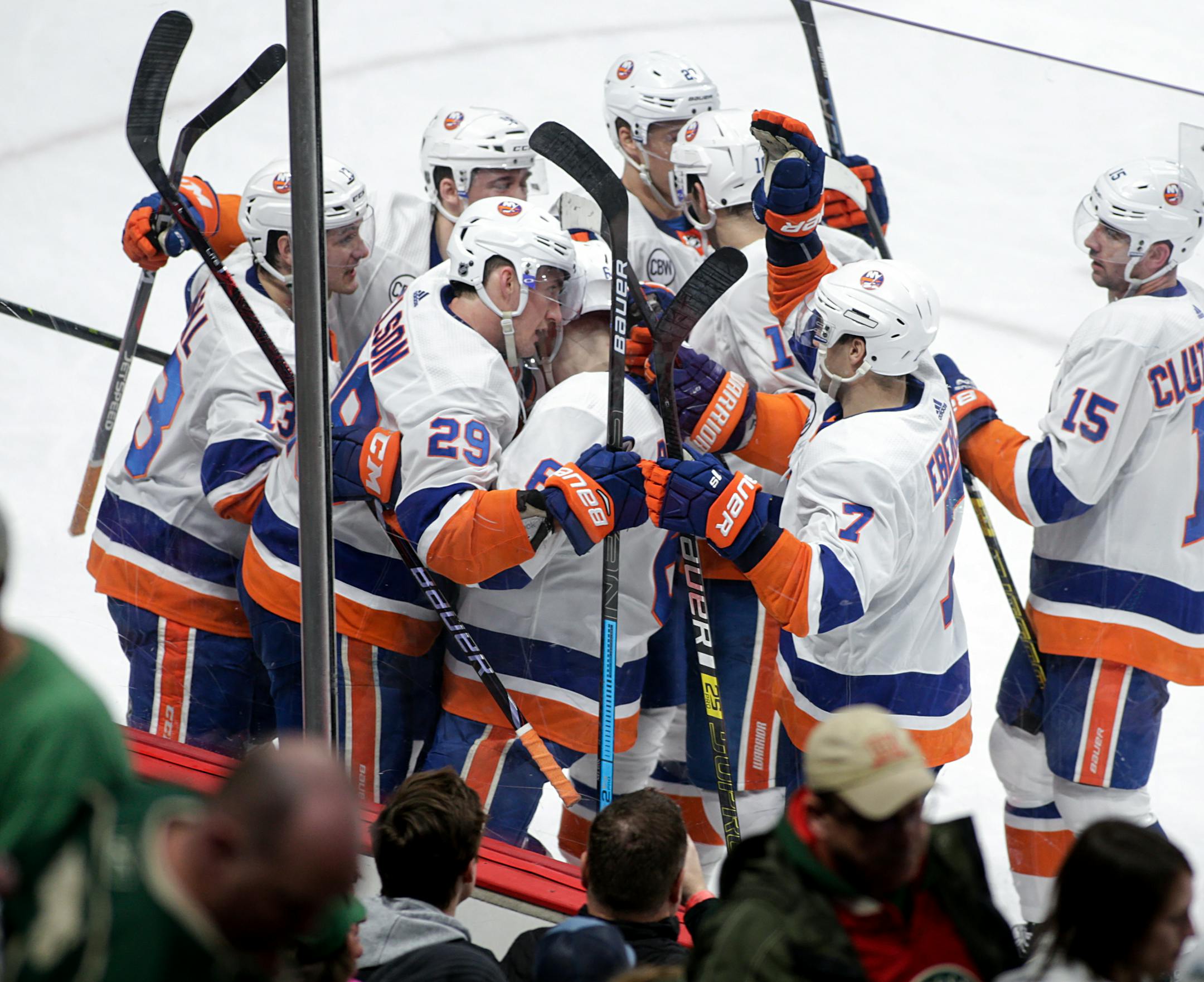 New York Islanders center Brock Nelson (29) is surrounded by teammates after he scored the wining goal in overtime of an NHL hockey game against the Minnesota Wild Sunday, March 17, 2019, in St. Paul, Minn. The Islanders won 3-2 in overtime. (AP Photo/Paul Battaglia)
