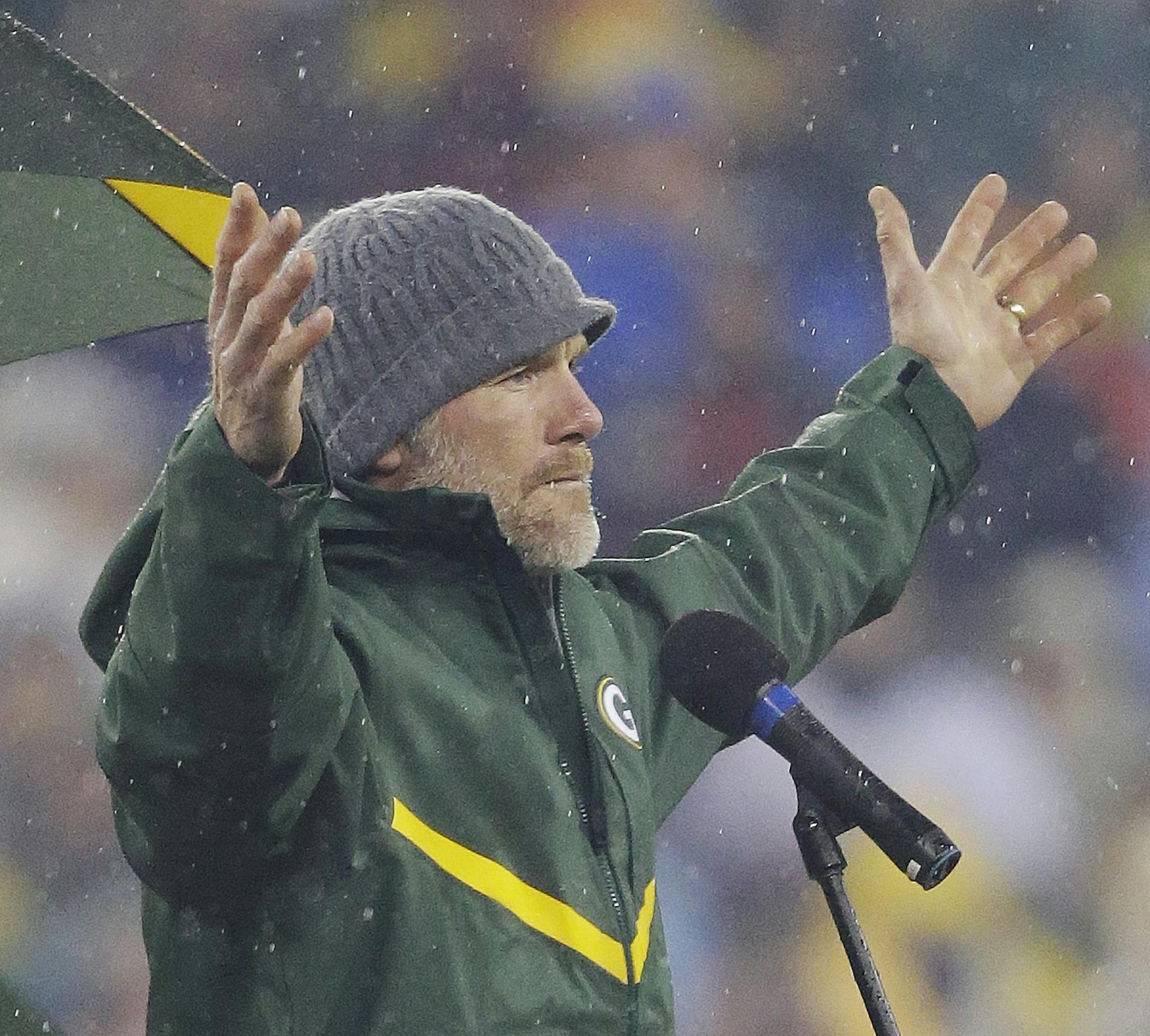 Brett Favre acknowledges the crowd during a ceremony at halftime of an NFL football game between the Green Bay Packers and Chicago Bears Thursday, Nov. 26, 2015, in Green Bay, Wis. Favre’s retired No. 4 and name were unveiled inside Lambeau Field during the ceremony. (AP Photo/Jeffrey Phelps)