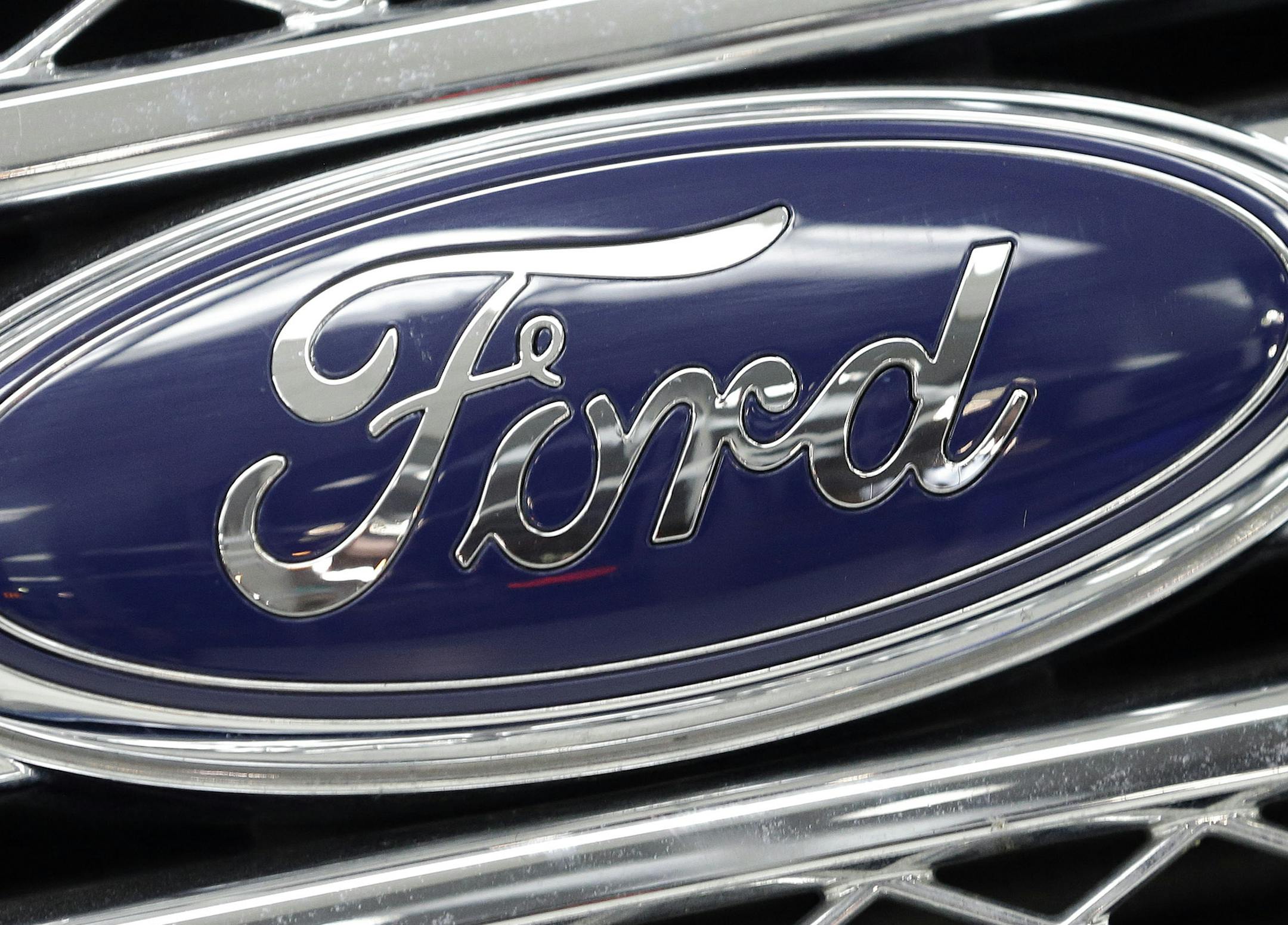 FILE - In this Monday, Jan. 5, 2015, file photo, the Ford logo shines on the front grille of a 2014 Ford F-150, on display at a local dealership in Hialeah, Fla. The United Auto Workers' proposed contract with Ford Motor Co. ó approved Monday, Nov. 9, 2015, by local union leaders ó is the richest of the Detroit Three. (AP Photo/Alan Diaz, File) ORG XMIT: NY124