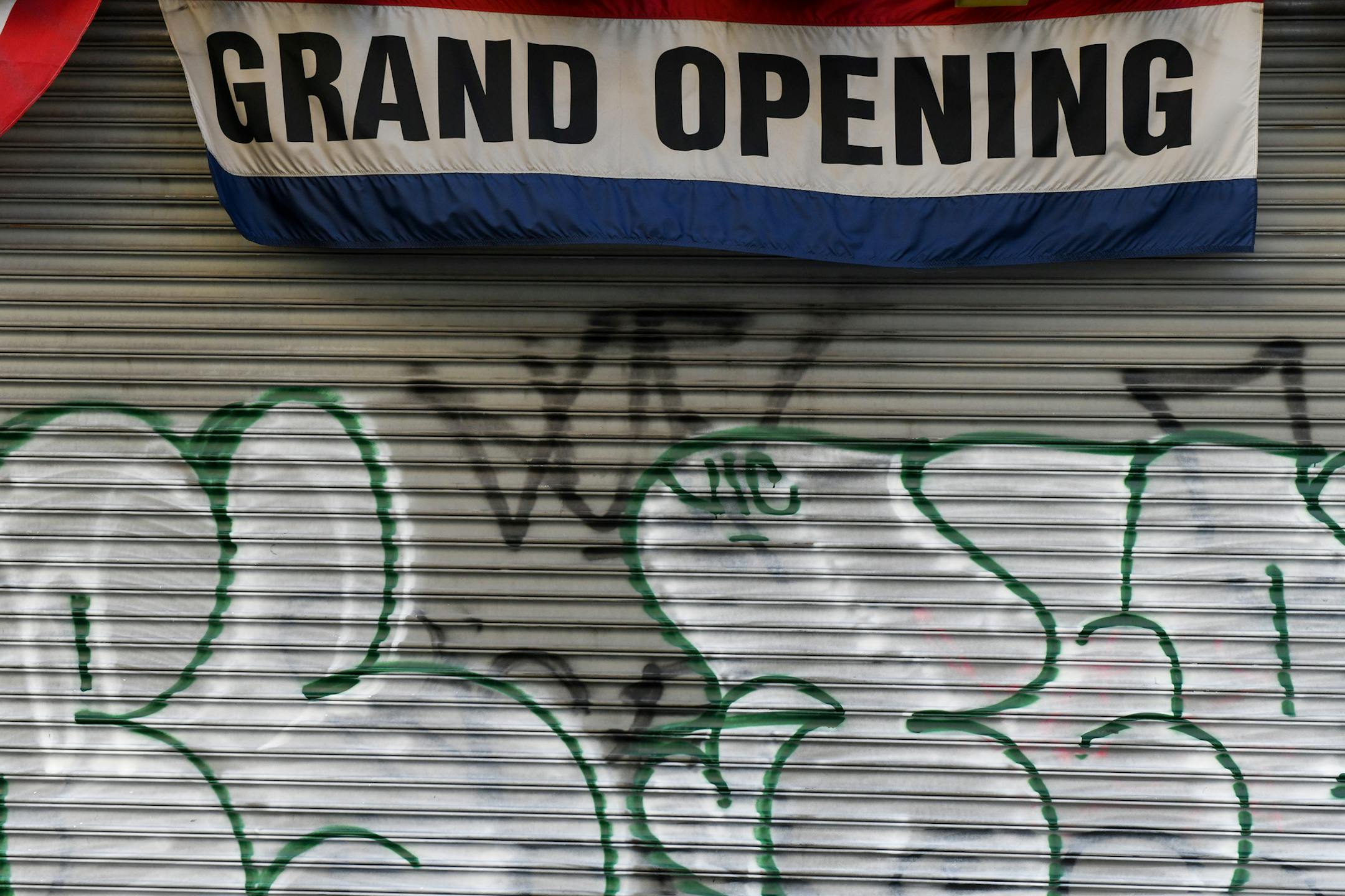 A grand opening sign hangs above a storefront, shuttered due to social distancing efforts to slow the spread of the coronavirus, in the Bronx, April 2, 2020. The longest stretch of job creation in American history came to a halt last month, the Labor Department reported Friday, April 3, 2020, another reflection of the coronavirus pandemic that has brought the economy to a virtual standstill. (Desiree Rios/The New York Times)