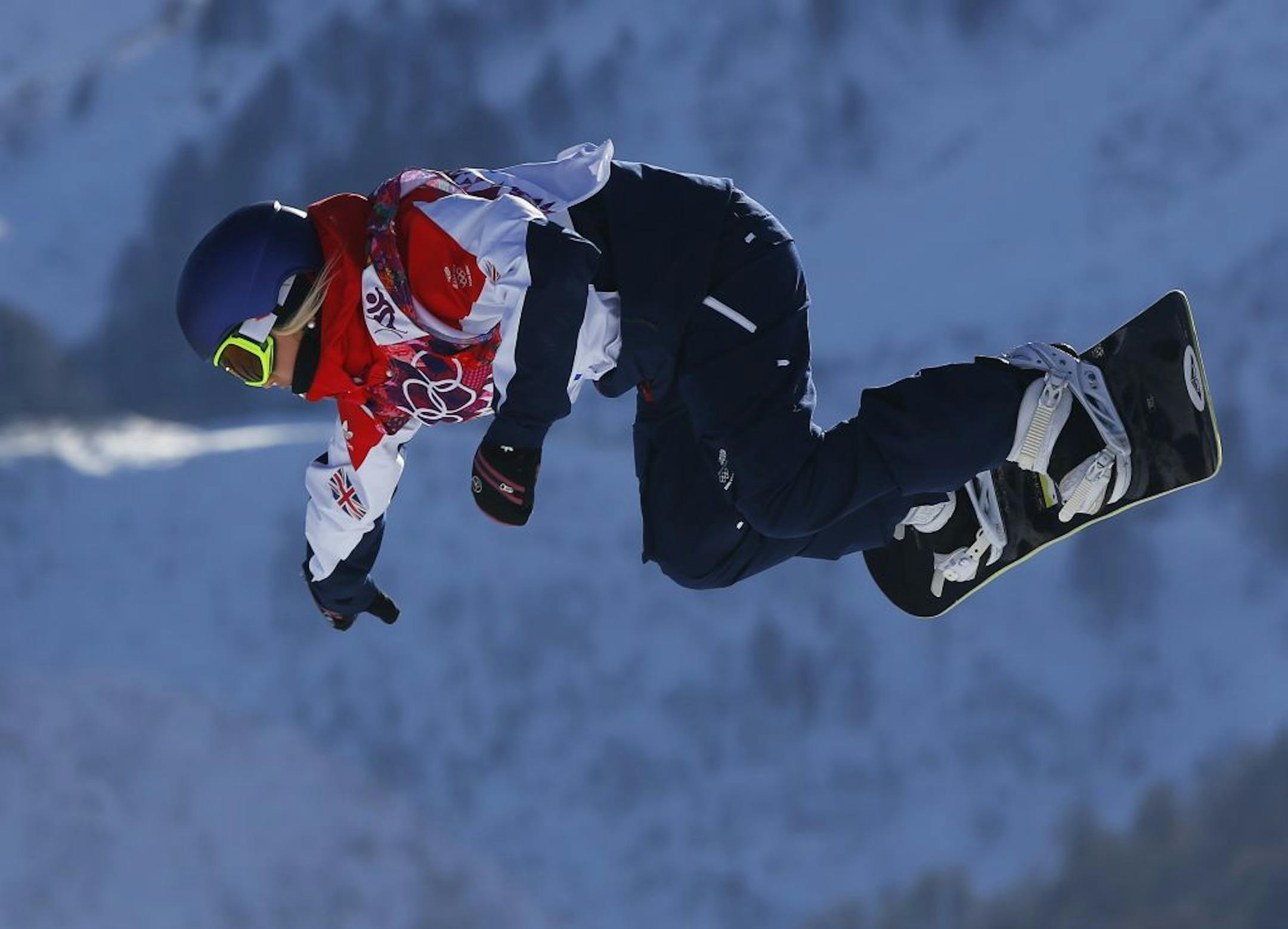 Britain's Aimee Fuller takes a jump during the women's snowboard slopestyle qualifying at the Rosa Khutor Extreme Park ahead of the 2014 Winter Olympics, Thursday, Feb. 6, 2014, in Krasnaya Polyana, Russia.