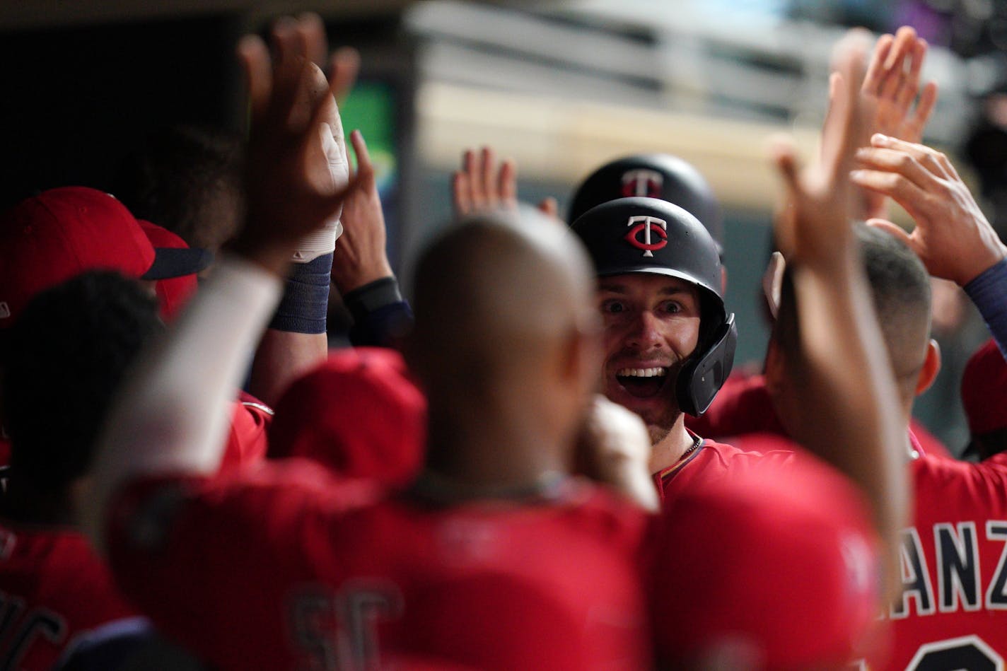 Minnesota Twins catcher Mitch Garver (18) celebrated with his teammates in the dugout after hitting a game winning, two-run home run in the eighth inning.