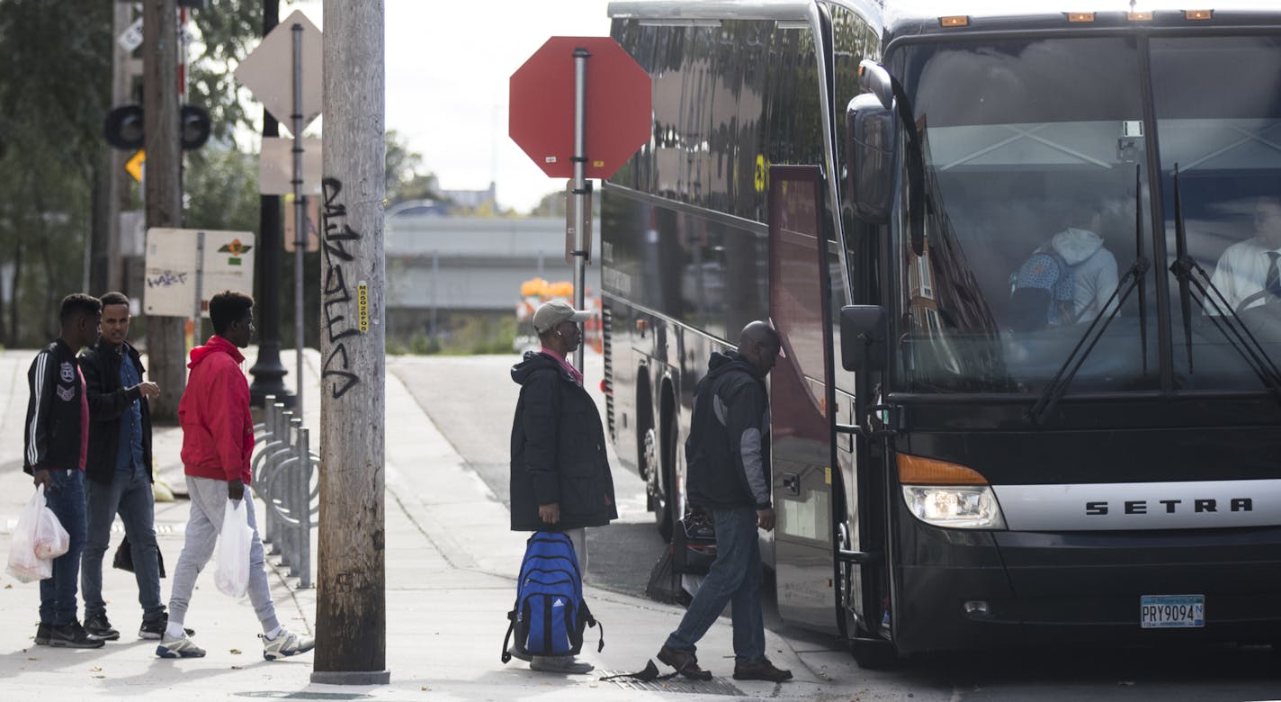 Workers boarded a charter bus for their commute from Cedar-Riverside in Minneapolis to Amazon in Shakopee.