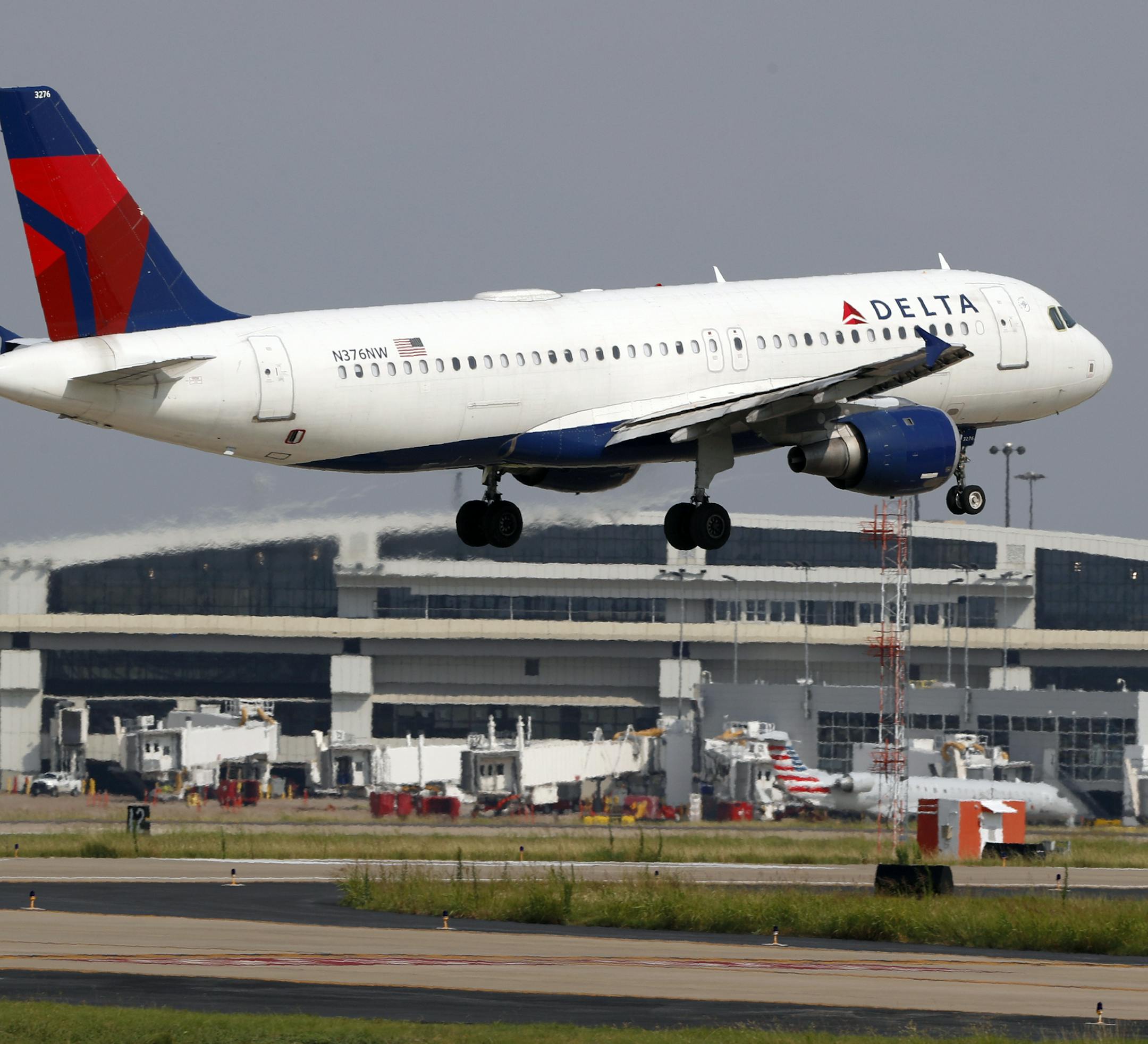 FILE - In this June 24, 2019, file photo a Delta Air Lines aircraft makes its approach at Dallas-Fort Worth International Airport in Grapevine, Texas. Delta Air Lines, Inc. reports earnings Wednesday, July 10. (AP Photo/Tony Gutierrez, File)