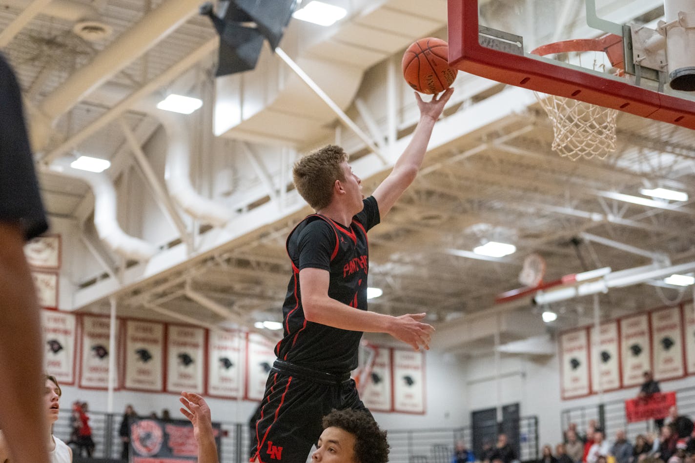 Lakeville North and East Ridge opened Tuesday with a matchup ripped from the Class 4A boys basketball top 10. No. 2 Lakeville North defeated No. 9 East Ridge 87-56. Jack Robison (pictured) scored 17 points for Lakeville North.