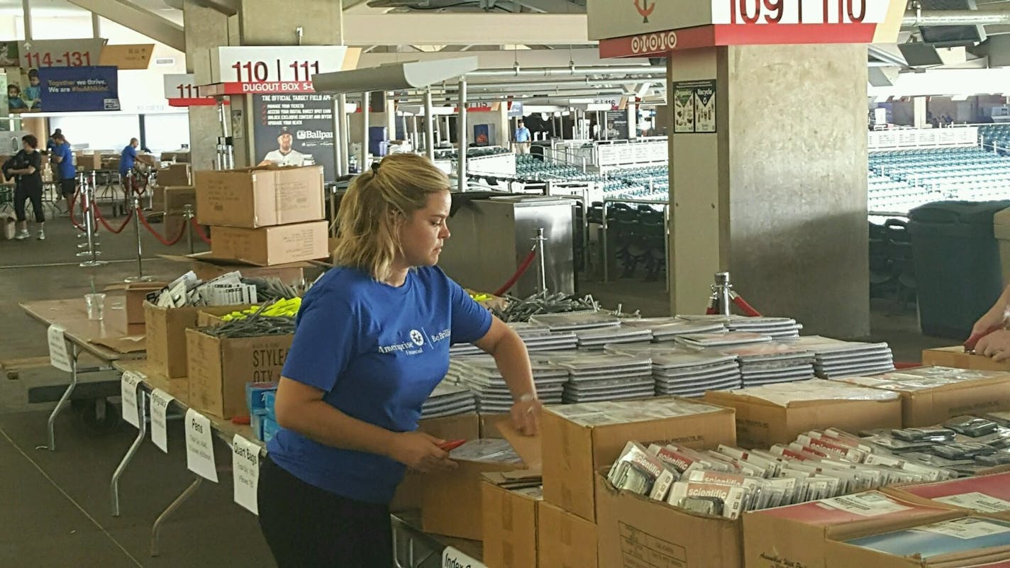 Volunteer Megan Yoshida organizes school supplies for the The Greater Twin Cities United Way's 6th Annual Action Day. Thousands of volunteers will pack 9,000 backpacks and snackpacks for needy kids at Target Field Thursday evening followed by a free concert. Photo by Shannon Prather