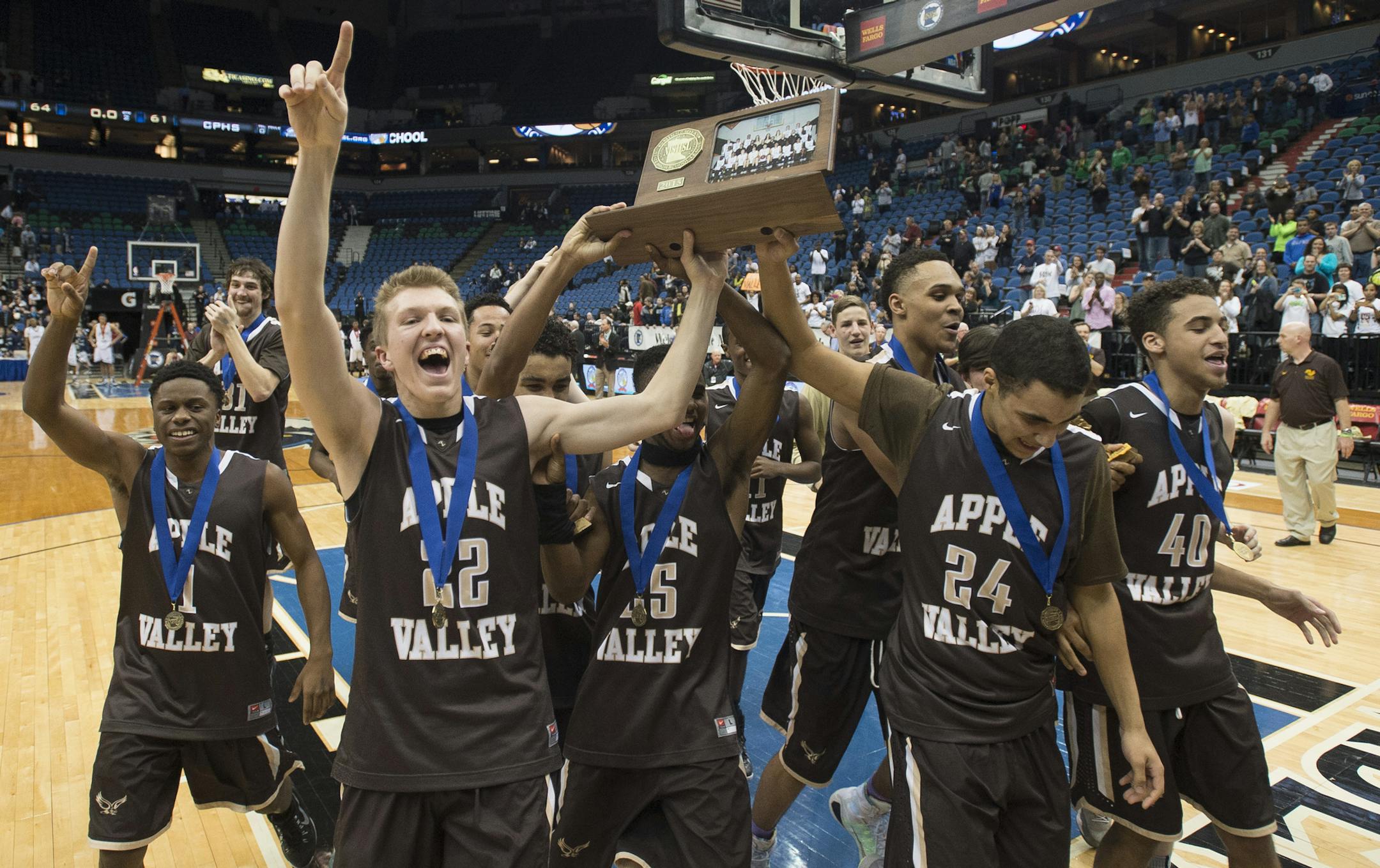 The Apple Valley Eagles head toward the student section with their championship trophy after defeating Champlin Park 64-61. ] (Aaron Lavinsky | StarTribune) Champlin Park takes on Apple Valley in the Class 4A boys' basketball championship game on Saturday, March 14, 2014 at Target Center.