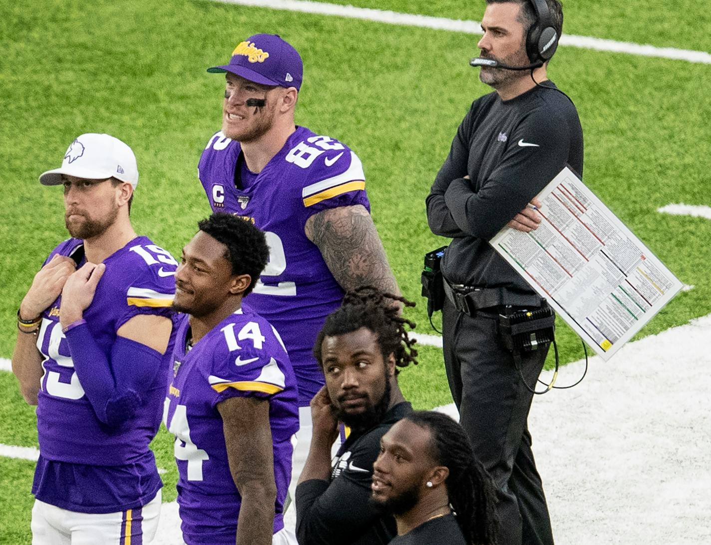 Vikings players Kyle Rudolph, Adam Thielen, Stefon Diggs, Dalvin Cook and Alexander Mattison stood on the sidelines in the fourth quarter.