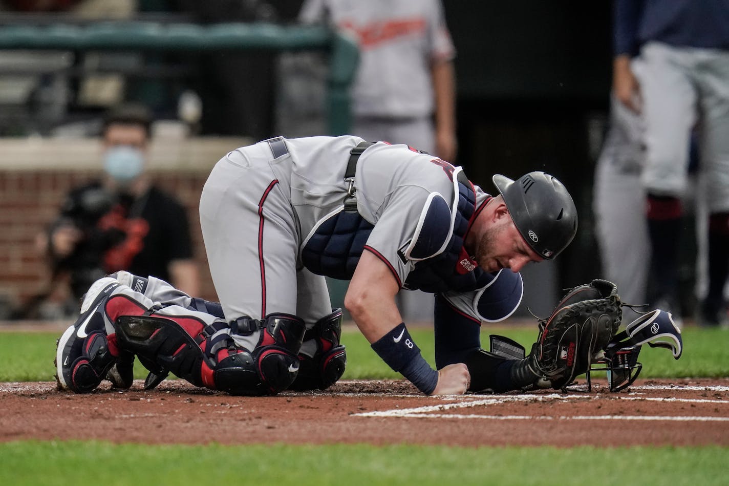 Minnesota Twins catcher Mitch Garver reacts after taking a foul ball from Baltimore Orioles designated hitter Trey Mancini during the first inning of a baseball game, Tuesday, June 1, 2021, in Baltimore. (AP Photo/Julio Cortez)