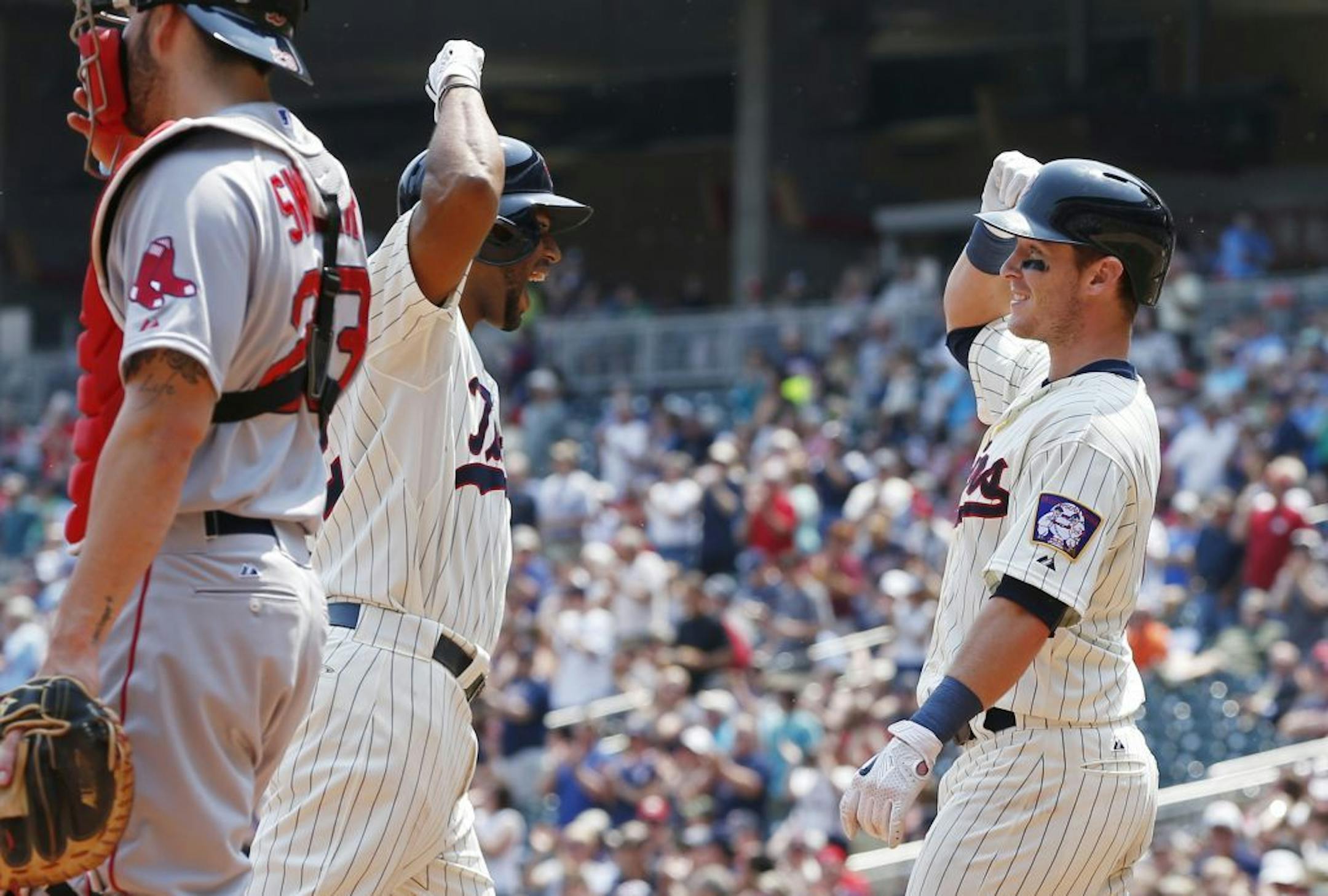 Minnesota Twins� Aaron Hicks, left, and Chris Herrmann celebrate Hicks' two-run home run off Boston Red Sox� pitcher Rick Porcello in the fourth inning of a baseball game, Wednesday May 27, 2015, in Minneapolis.