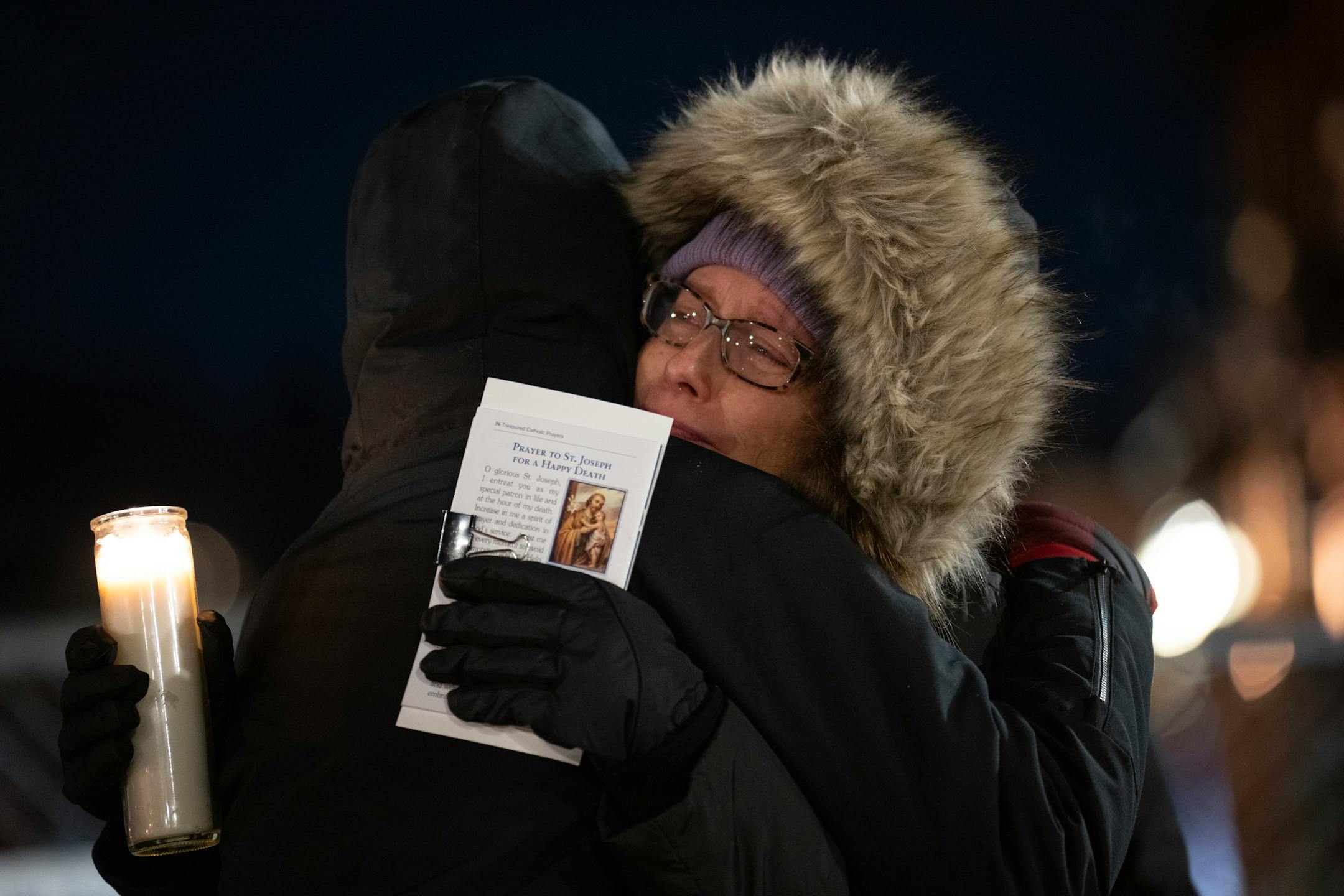 Nancy Musser was enveloped in a hug at the end of the vigil for her son, George.