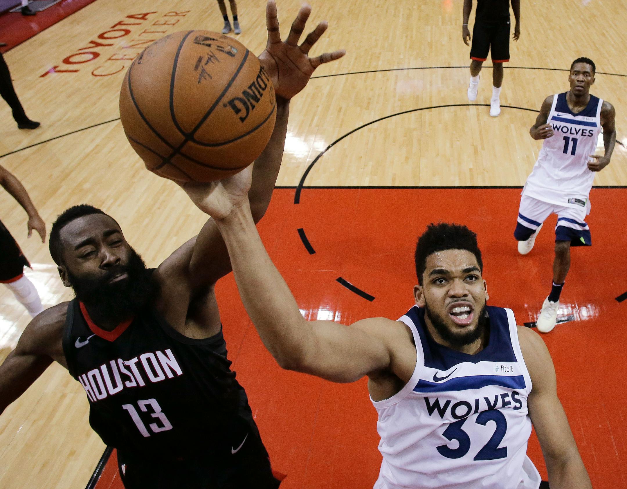 Rockets guard James Harden (13) blocks the shot of Timberwolves center Karl-Anthony Towns