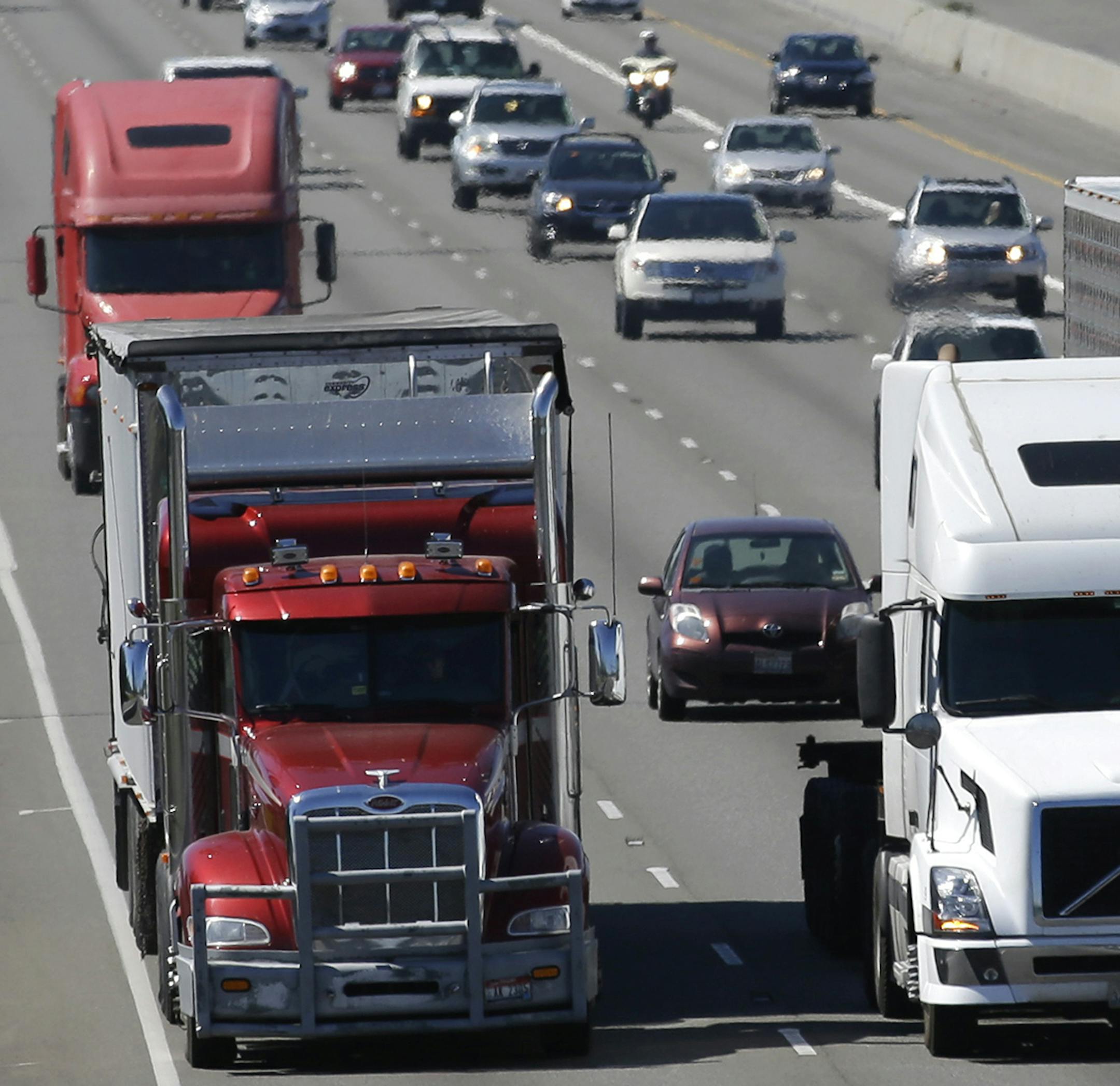 FILE - In this Wednesday, Aug. 24, 2016, file photo, truck and automobile traffic mix on Interstate 5, headed north through Fife, Wash., near the Port of Tacoma. Truckers are warning that a government plan to electronically limit the speed of tractor-trailer rigs will lead to highway traffic jams and even an increase in deadly run-ins with cars allowed to travel at faster speeds. (AP Photo/Ted S. Warren, File) ORG XMIT: MIN2017040512321517