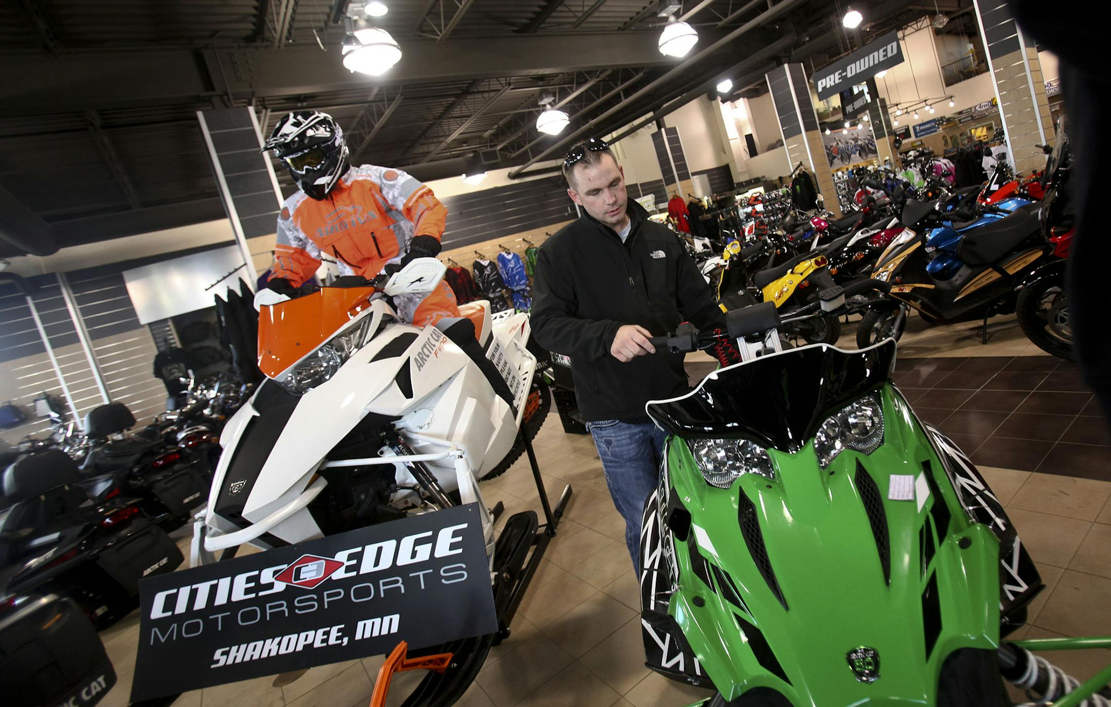 At Cities Edge Motorsports, customer Brandon Winter looked at one of the new Arctic Cats in Shakopee Thursday, October 27, 2011 ] (KYNDELL HARKNESS/STAR TRIBUNE) kyndell.harkness@startribune.com ORG XMIT: MIN2012091320211168