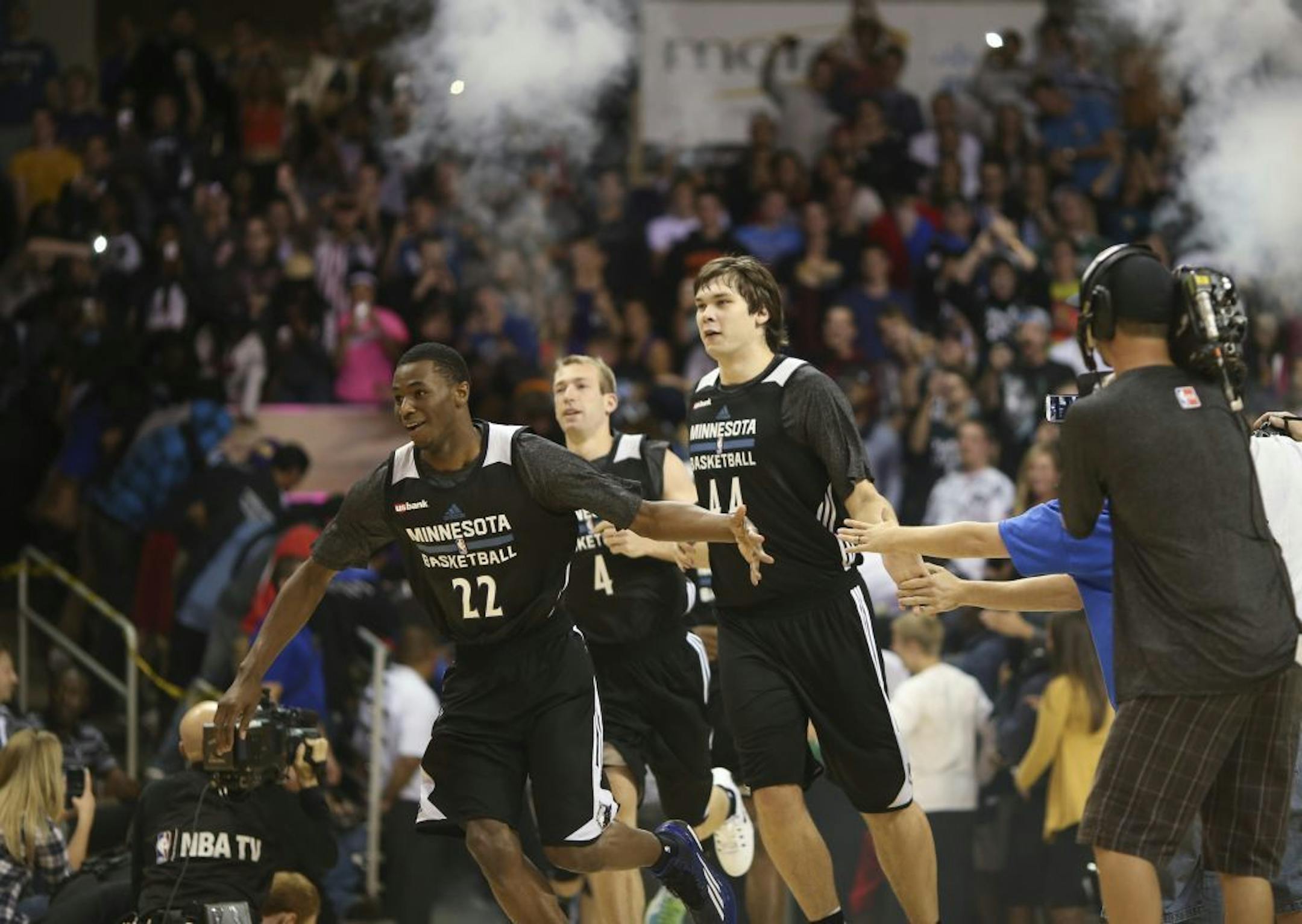 Andrew Wiggins slapped the hands of students as he ran onto the court at midnight for the first Timberwolves workout of the season early Tuesday morning at Bresnan Arena in Taylor Center in Mankato. He was followed by Kyrylo Fesenko (44) and Robbie Hummel (4).