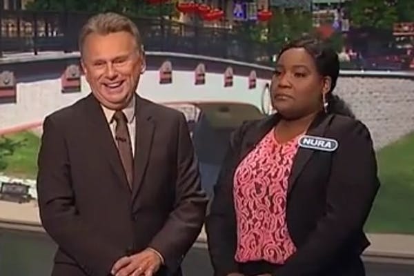 Contestant Nura appears with Pat Sajak on "Wheel of Fortune."