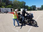 Minnesota Motorcycle Safety Center rider coach Lara Holland gives instructions to class participant Chris Hawkey