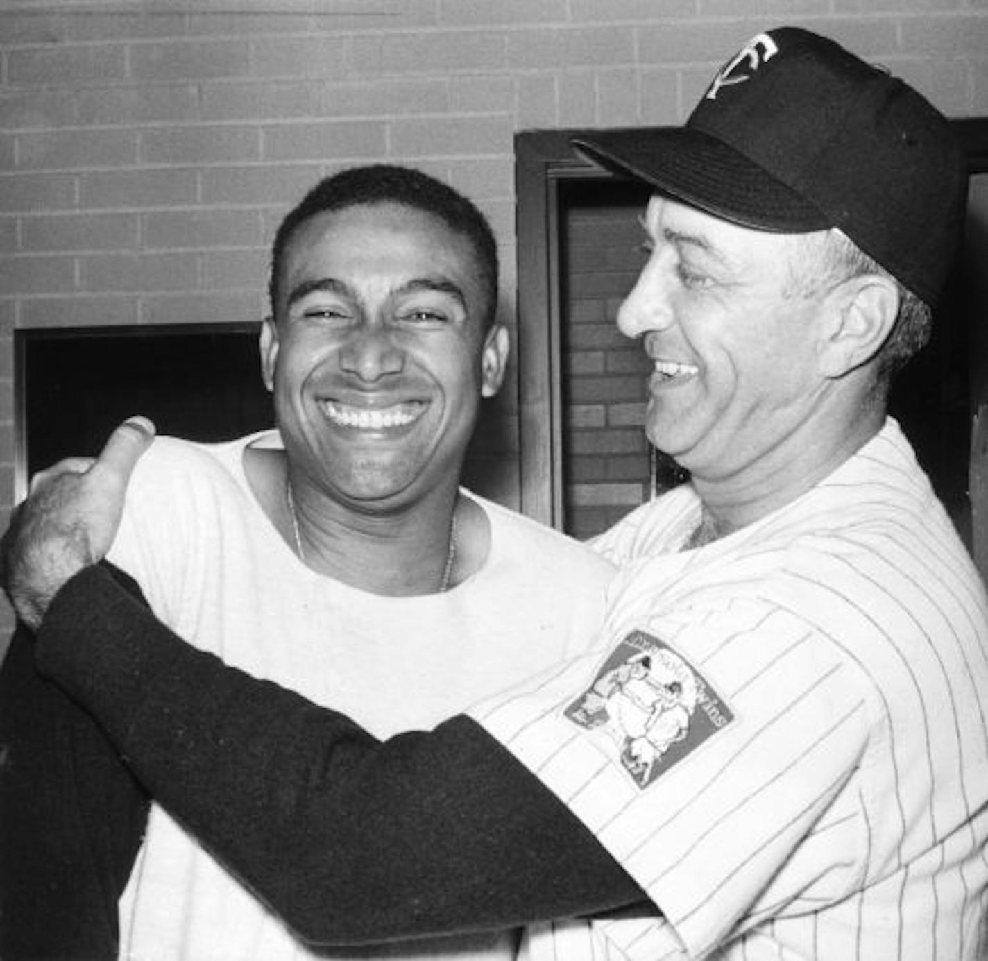 Julio Becquer gets a hug from manager Sam Mele after his game-winning grand slam on July 4, 1961.