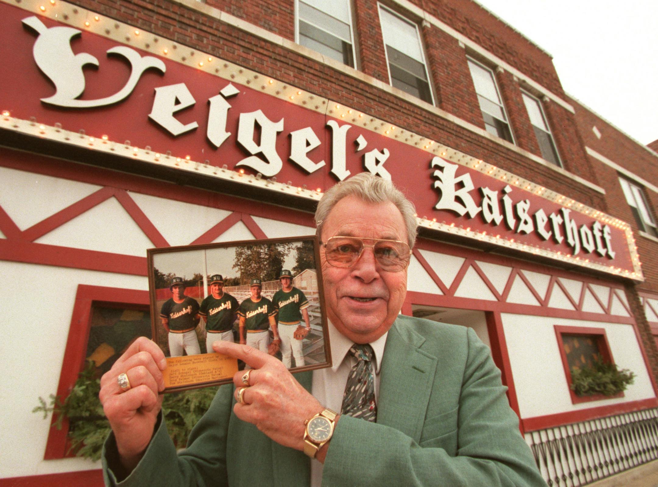 Town reaction to naming of Terry Steinbach to Twins -- Don Veigel, owner of the Kaiserhoff restaurant, shows off his picture of (l-r) Jeff Schugel, Terry Steinbach, Doug Palmer and Tom Steinbach when they were sponsored by his restaurant in the local league. They were all signed by major league teams in 1983.