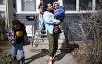 Mercedes Yarbrough picked up her children Meir, 2, and Matthew, 5, from daycare on Wednesday in St. Paul. Behind them, Rosalyn Smaller, who runs the d