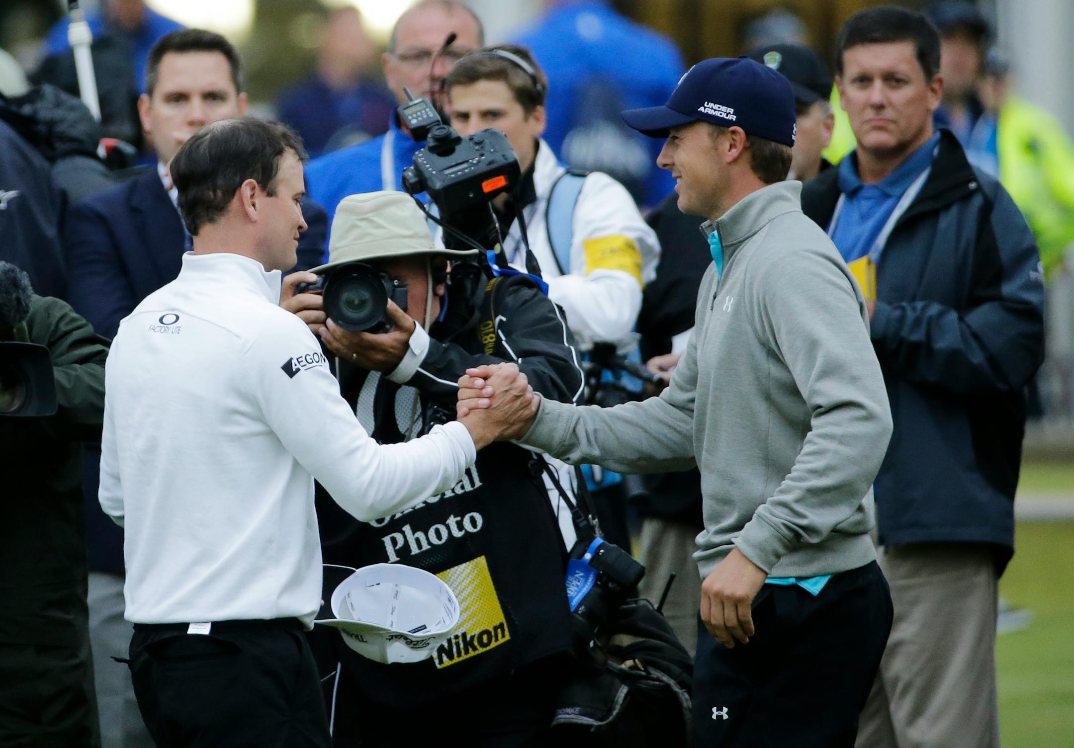 British Open winner Zach Johnson, left, received congratulations from Jordan Spieth, who finished one stroke out of Monday's playoff.