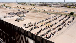 Migrants wait in lines to be processed by U.S. Border Patrol agents after crossing from Ciudad Juarez, Mexico, into El Paso, Texas, May 11, 2023. Offi