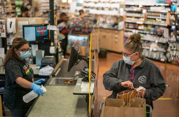 Masked employees in the Linden Hills Coop in Minneapolis after the first mandate was imposed in May 2020.