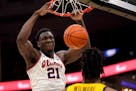 Illinois' Kofi Cockburn (21) dunks over Missouri's Jordan Wilmore during the first half of an NCAA college basketball game Wednesday, Dec. 22, 2021, i