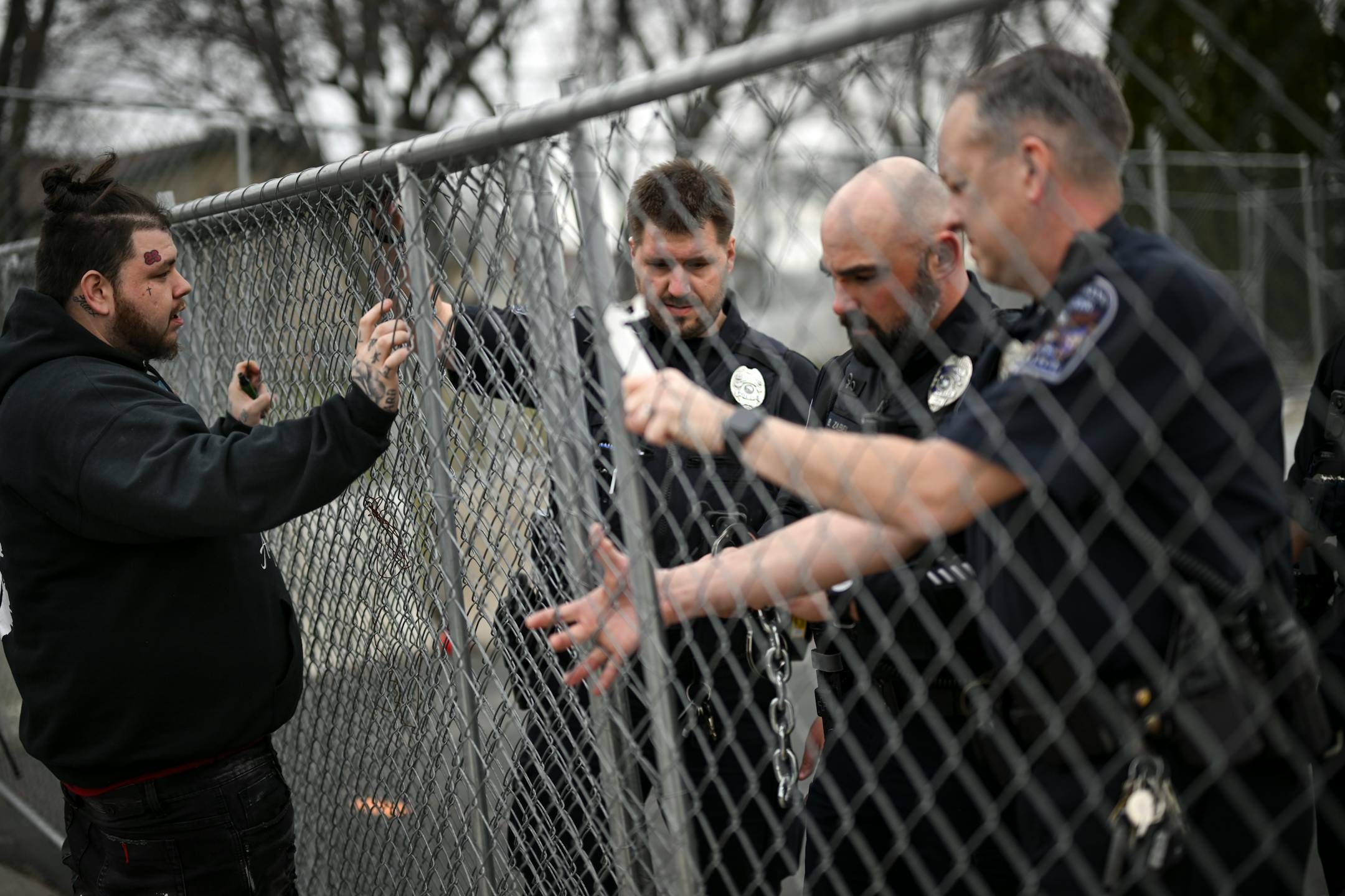 Damik Bryant, brother of Daunte Wright and son of Katie Wright, confronts a group of Brooklyn Center Police as they chain up a gate outside the station.